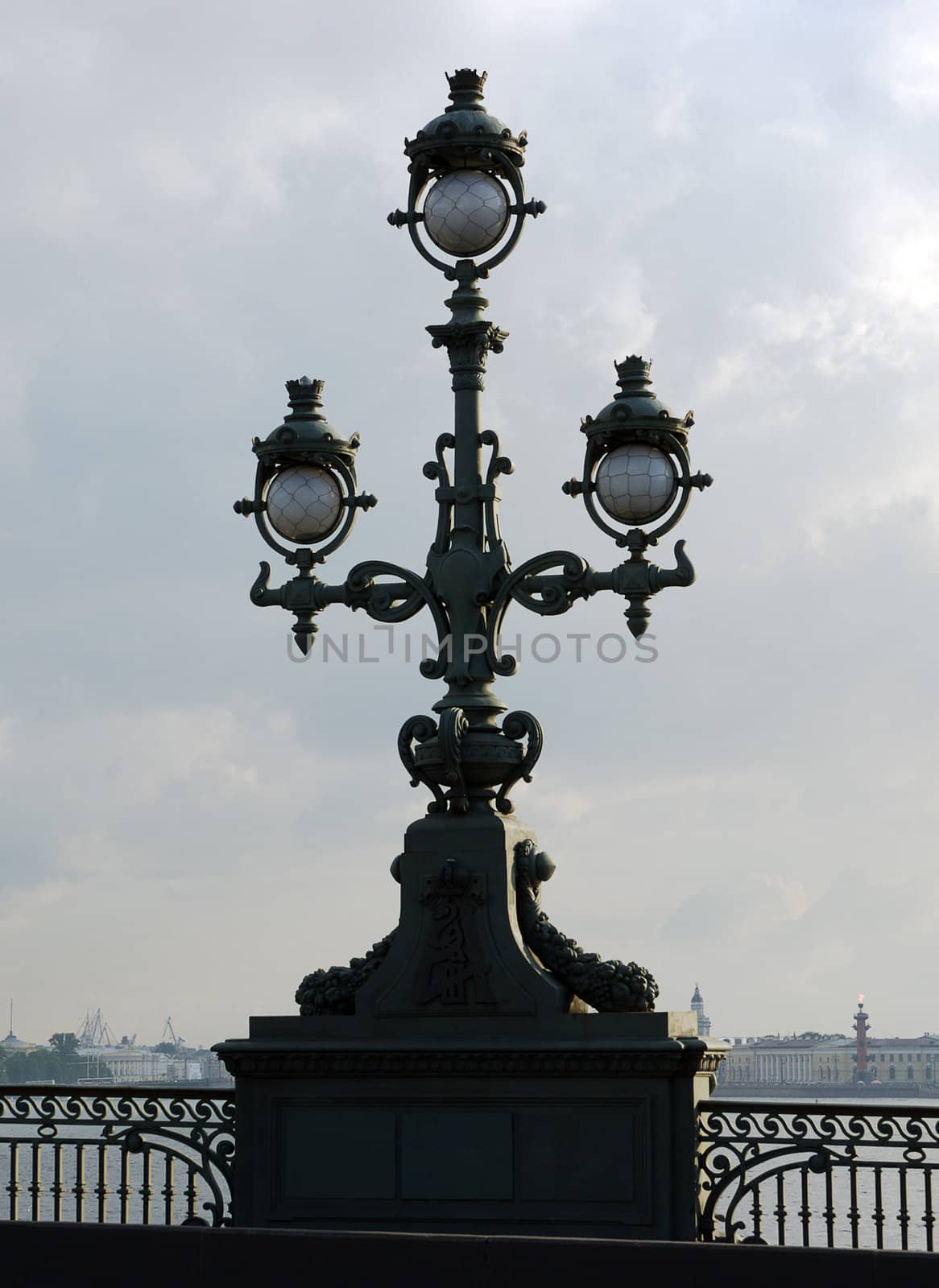 vintage street lamp on embankment of river on sky background