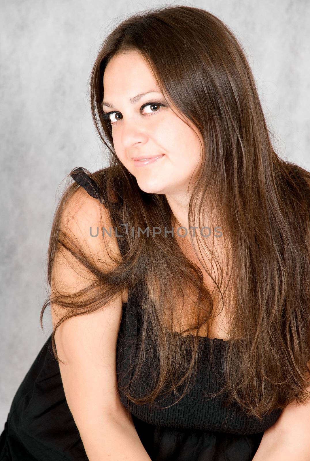 smiling young woman with long brown hair watching