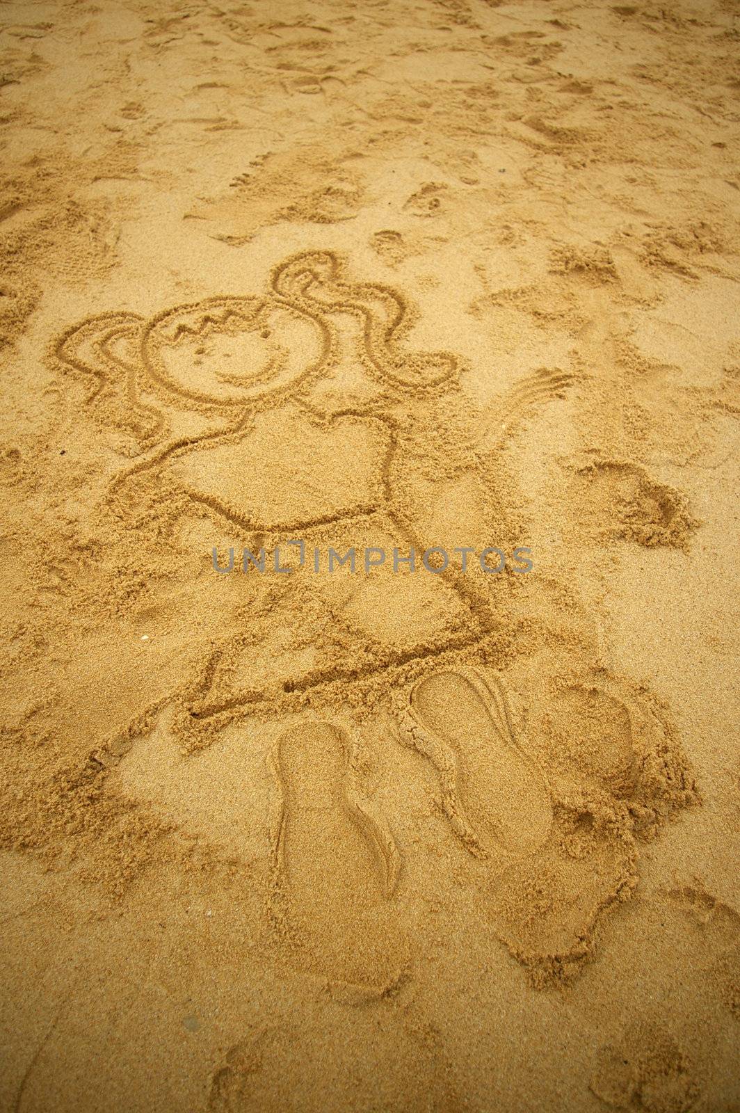Girl drawing on beach