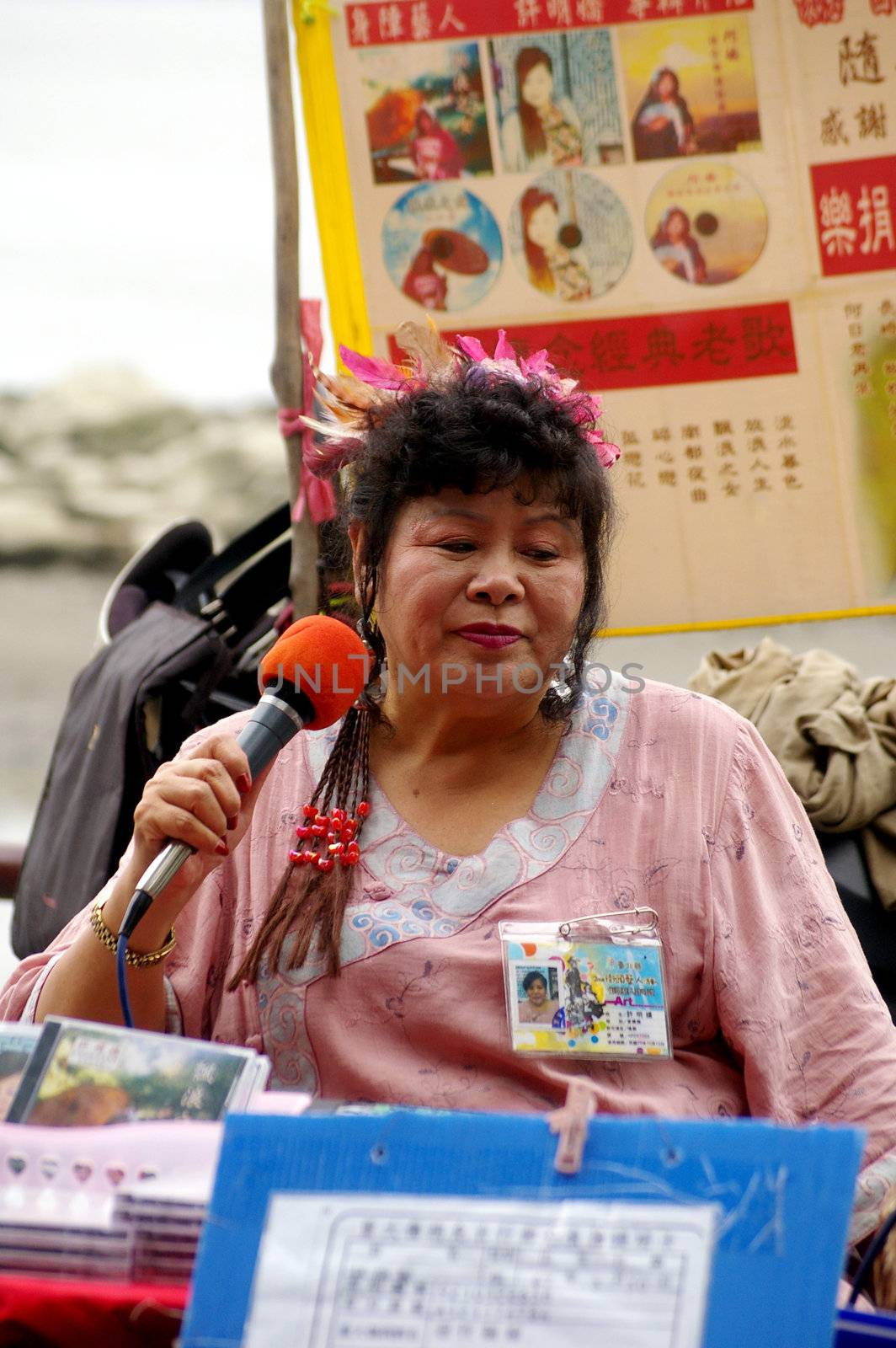 Woman singing along the street in Taipei, Taiwan by kawing921