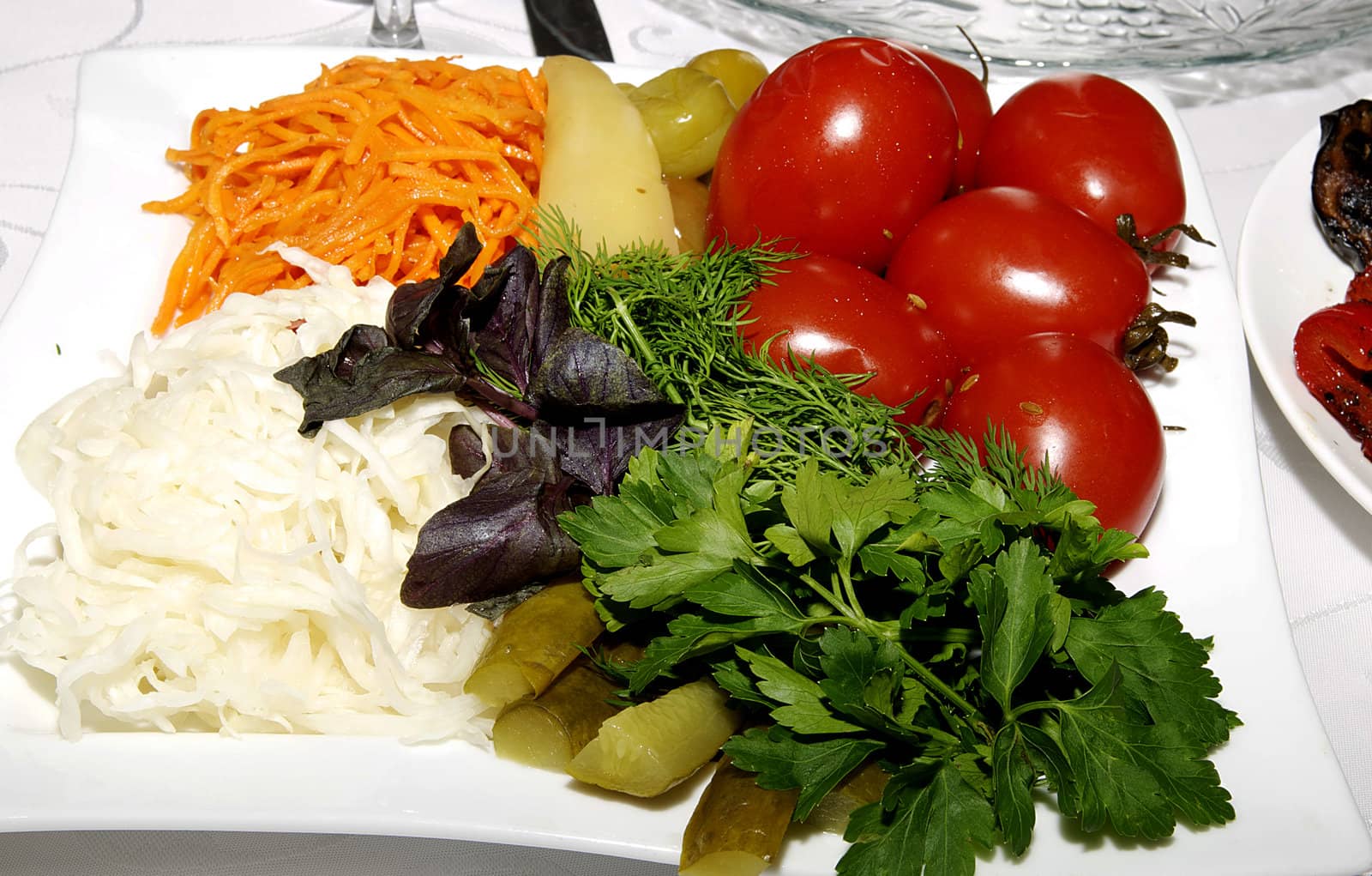 pickled vegetables on the plate on a white background