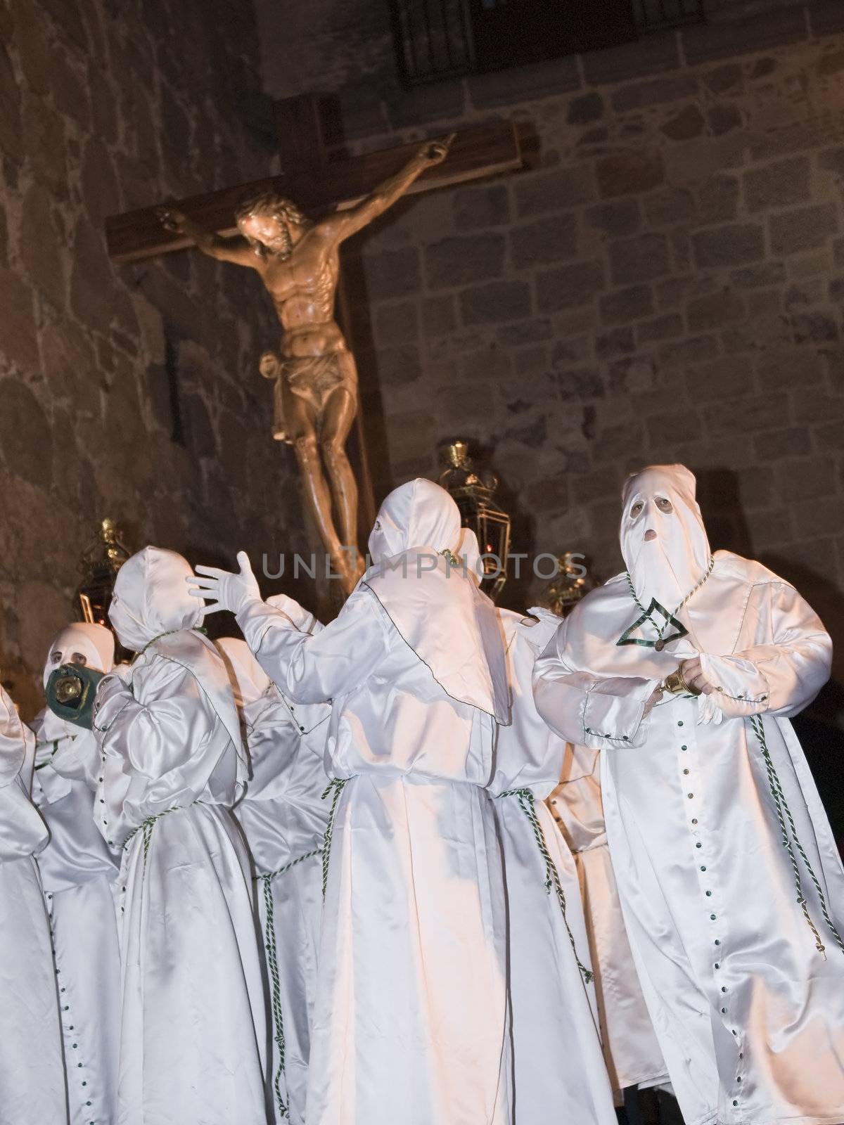 Easter nazarenes in white robe in a typical Spanish procession. 