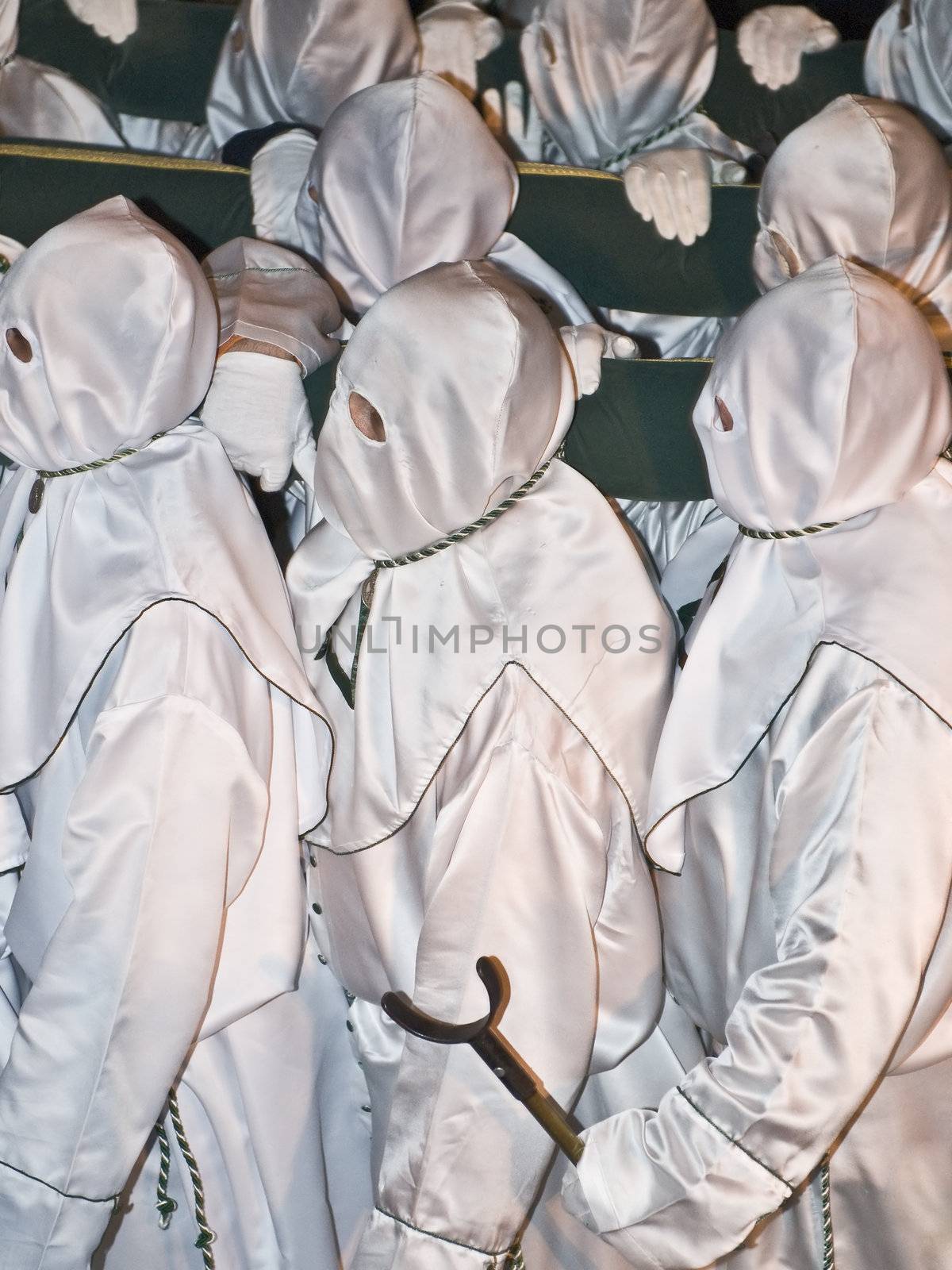 Easter nazarenes in white robe in a typical Spanish procession. 