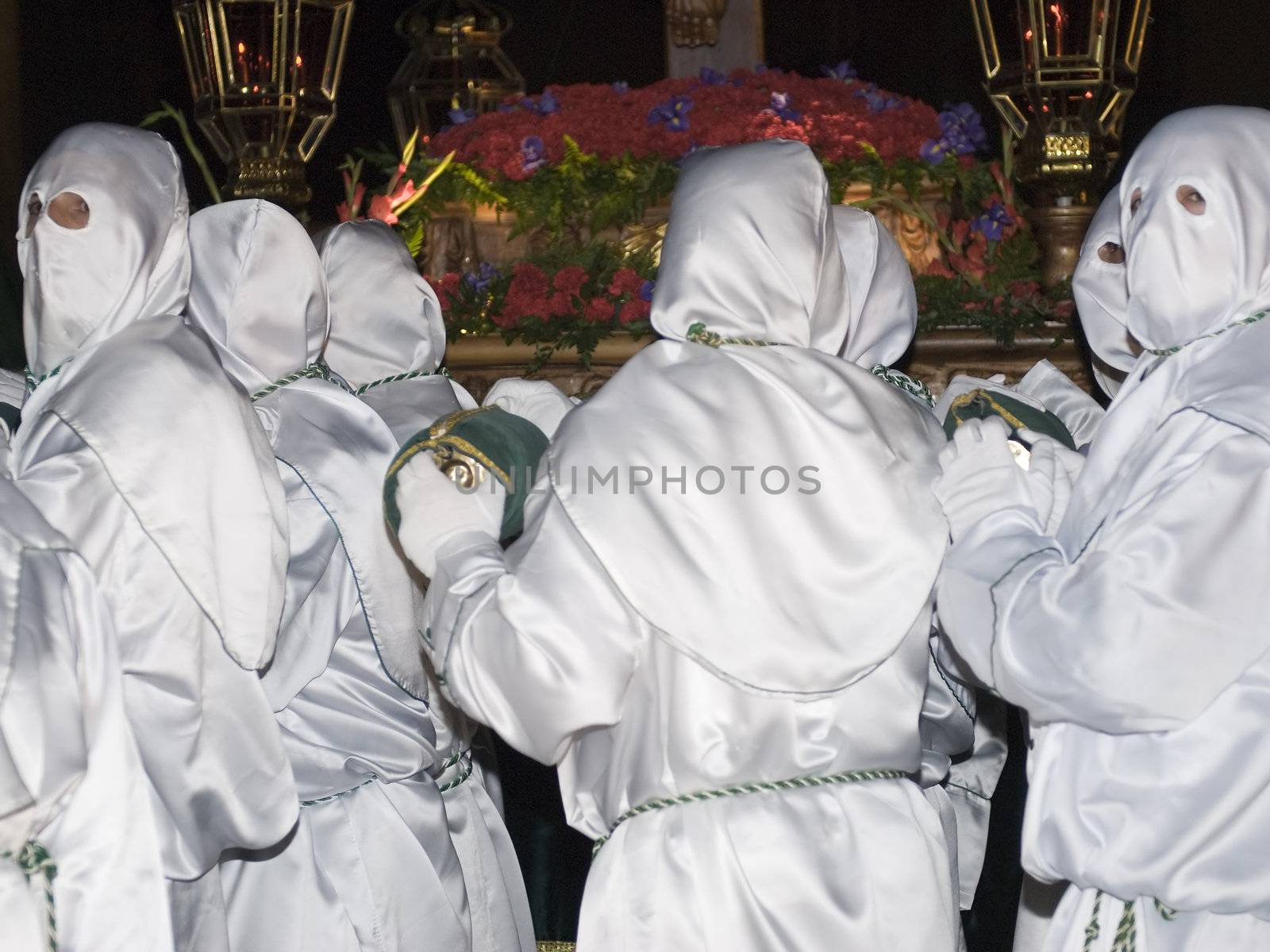 Easter nazarenes in white robe in a typical Spanish procession. 