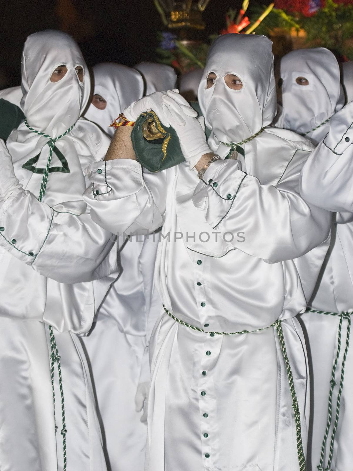 Easter nazarenes in white robe in a typical Spanish procession. 