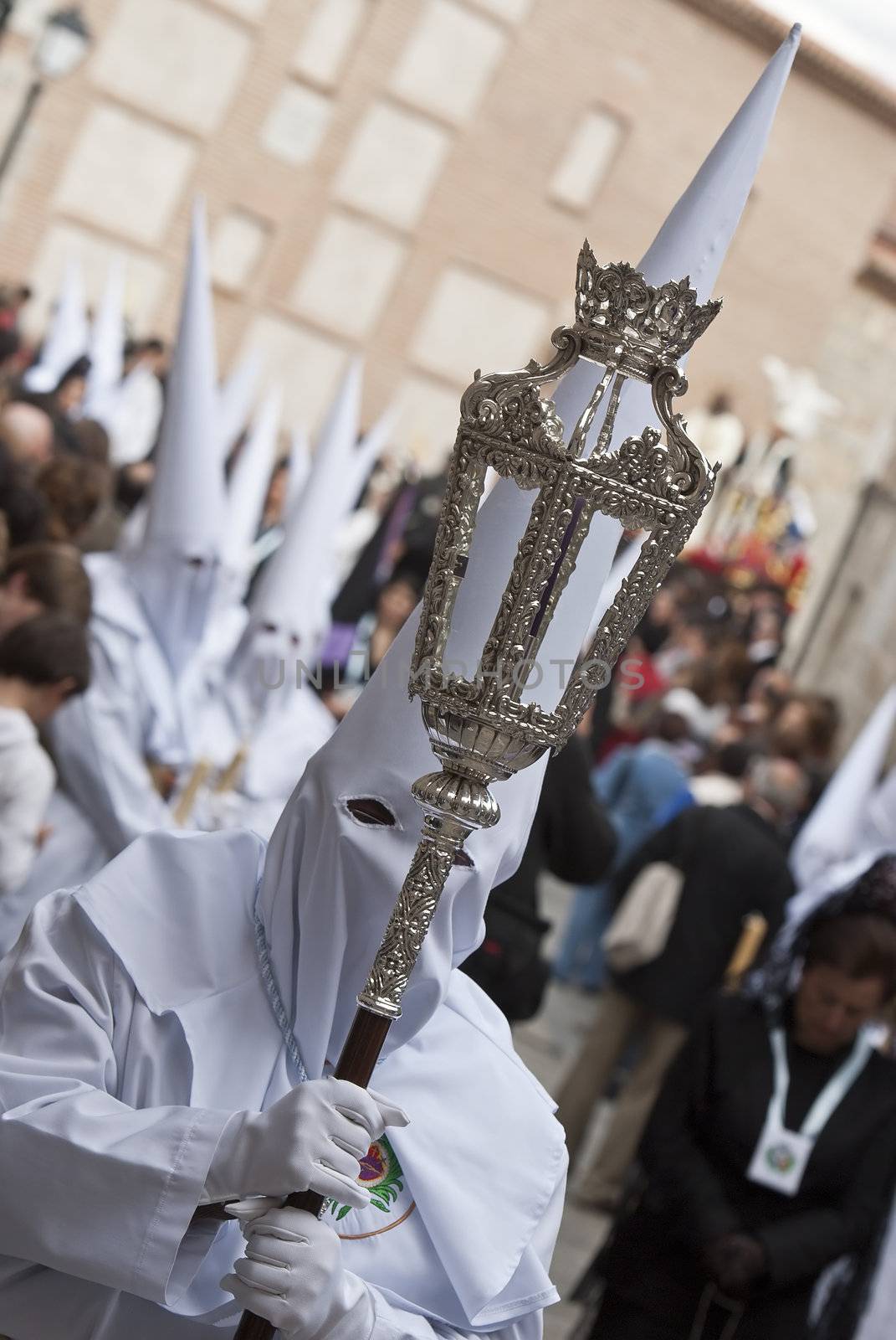 Easter nazarenes in white robe in a typical Spanish procession. 