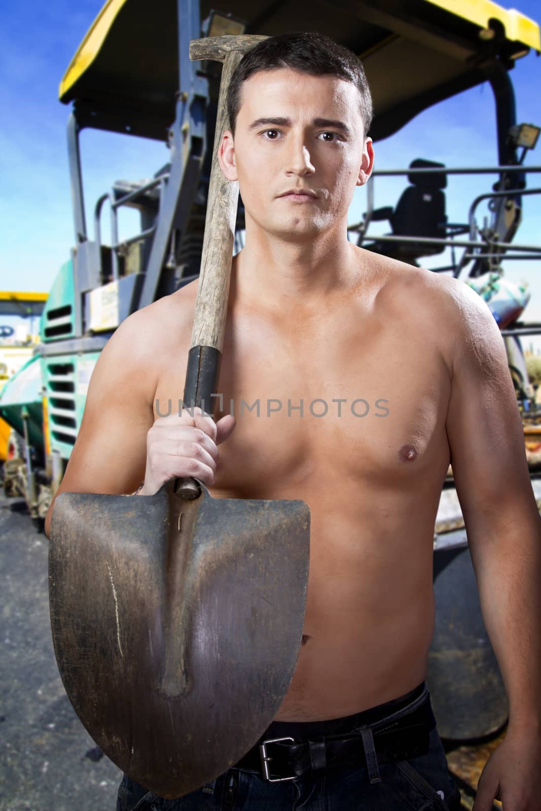 Young worker on road street repairing works