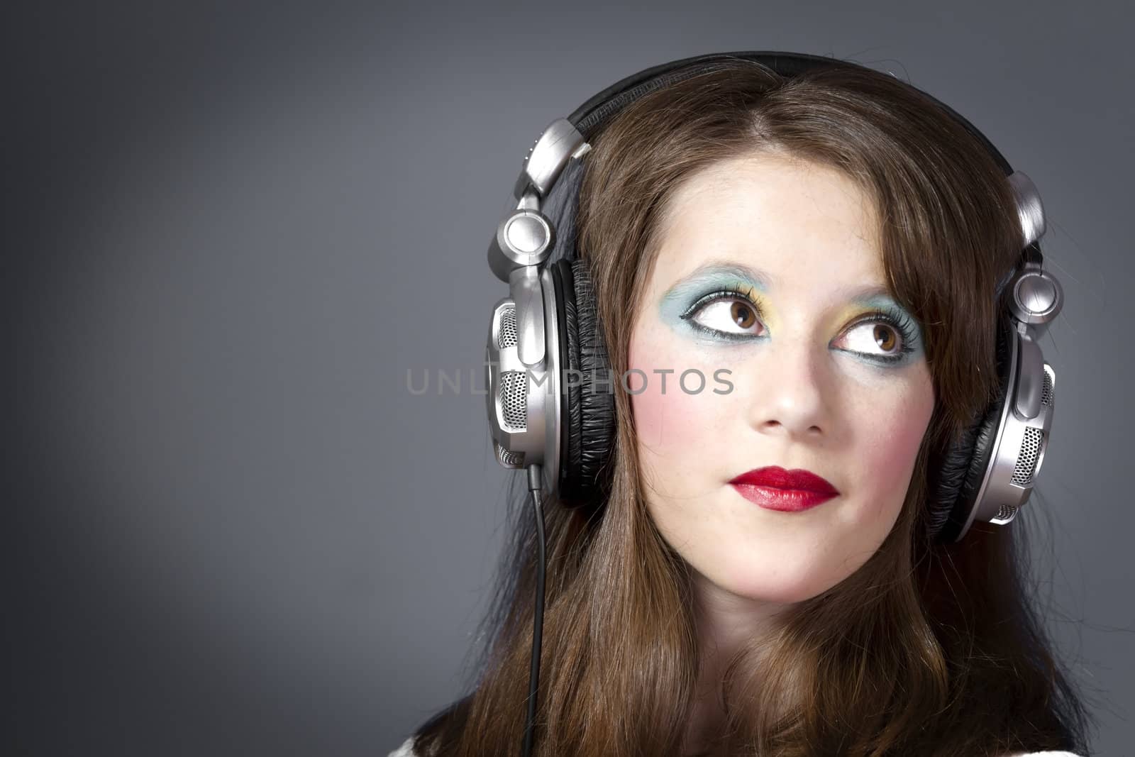 beautiful girl in headphones on a grey background