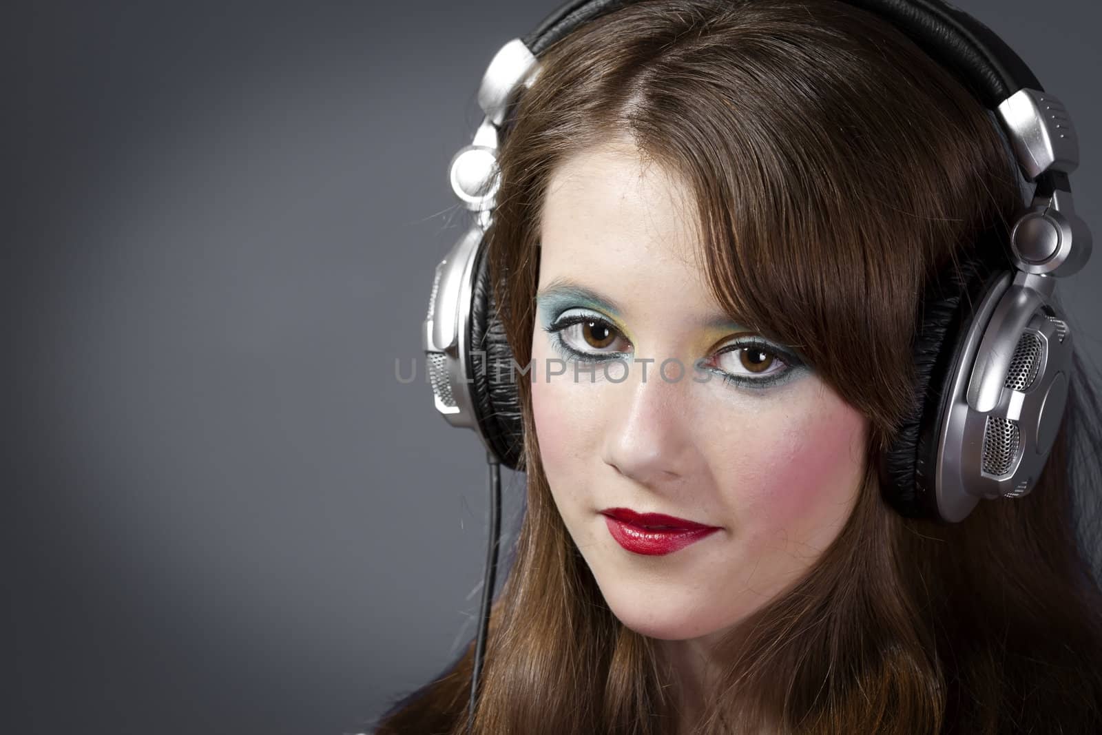 beautiful girl in headphones on a dark grey background