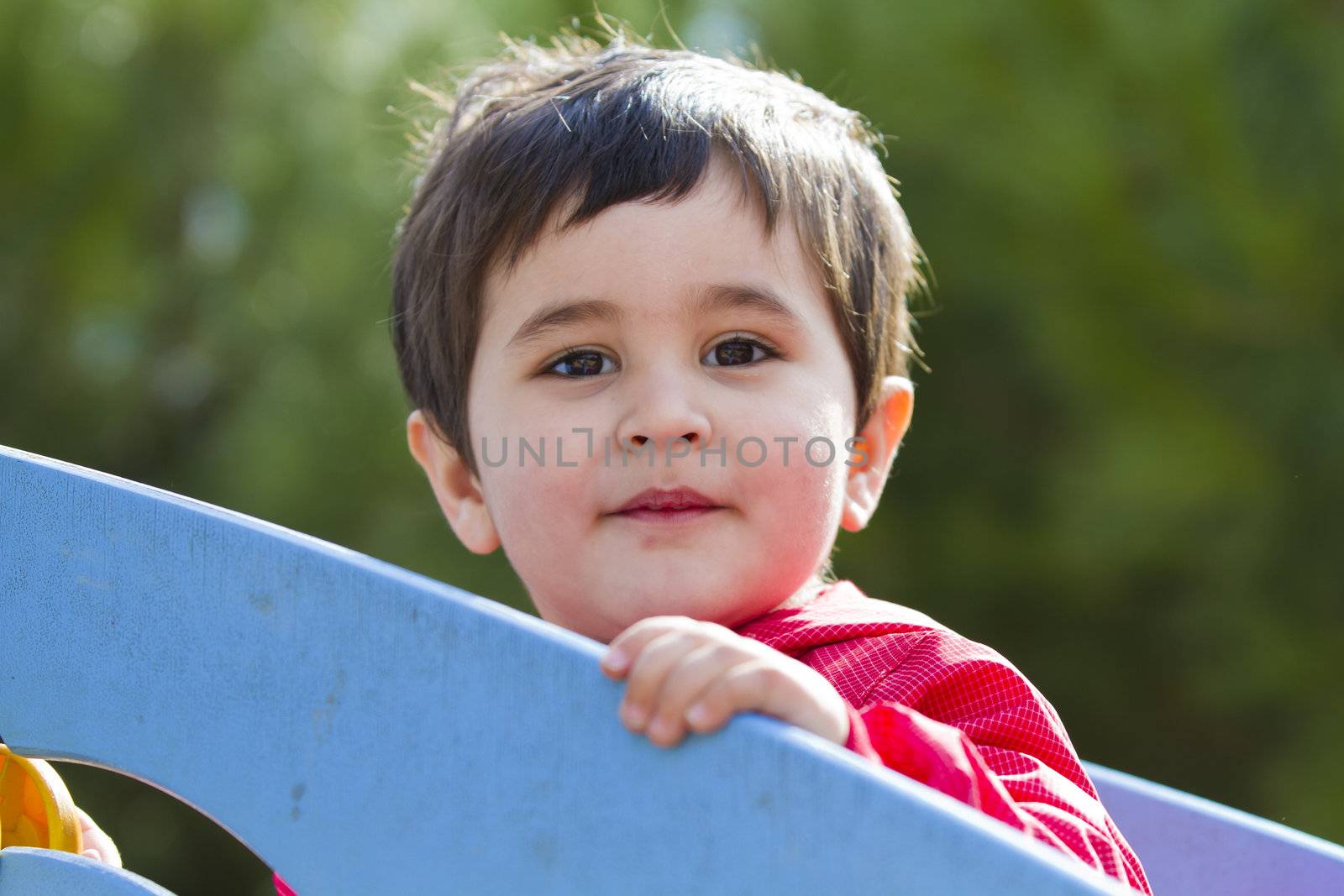 Cute little baby boy playing at park , smile