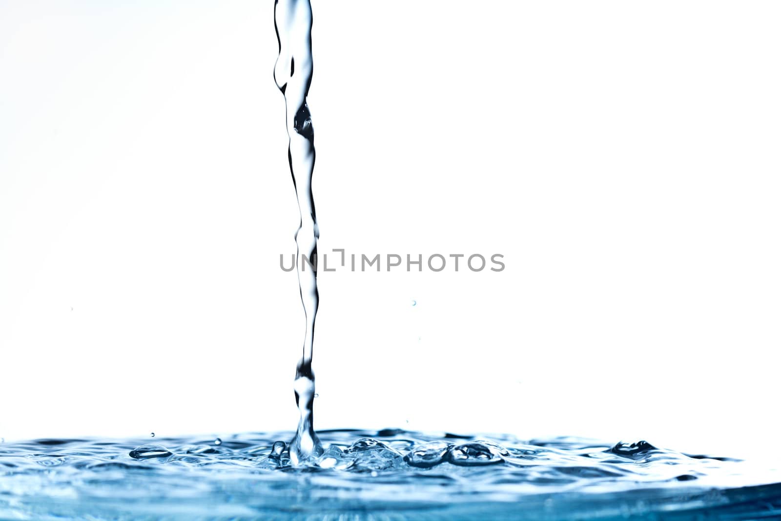 The fluid motion of water splashing as it is poured.