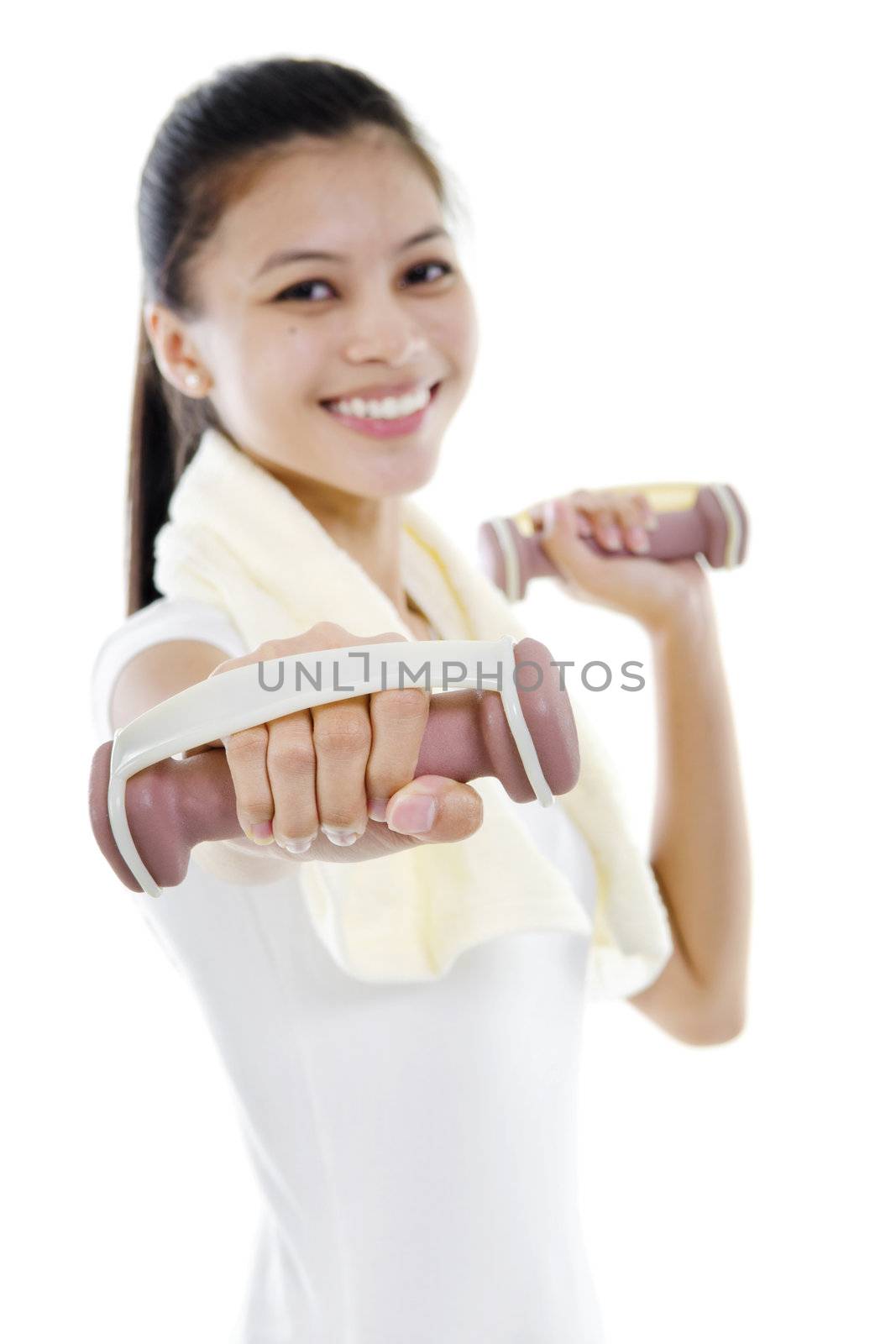 Portrait of fitness woman working out with free weights in studio