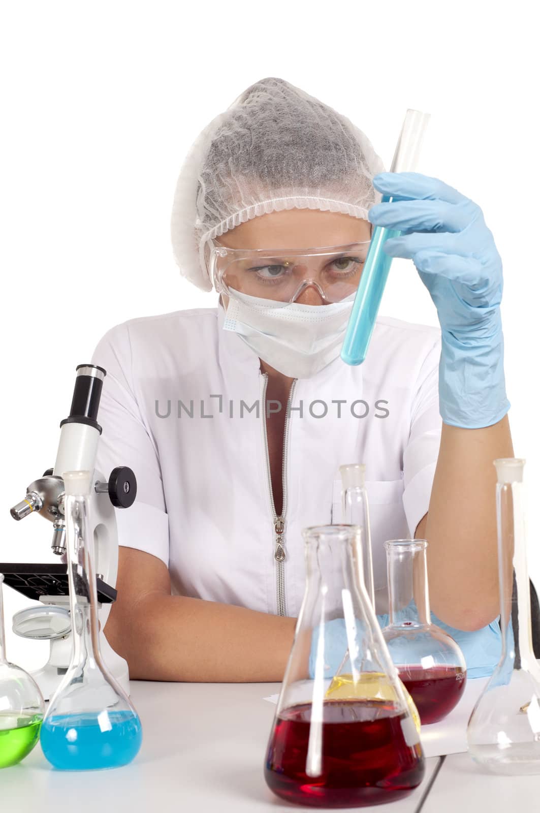 young woman scientist  chemist mixes the liquid in the tubes