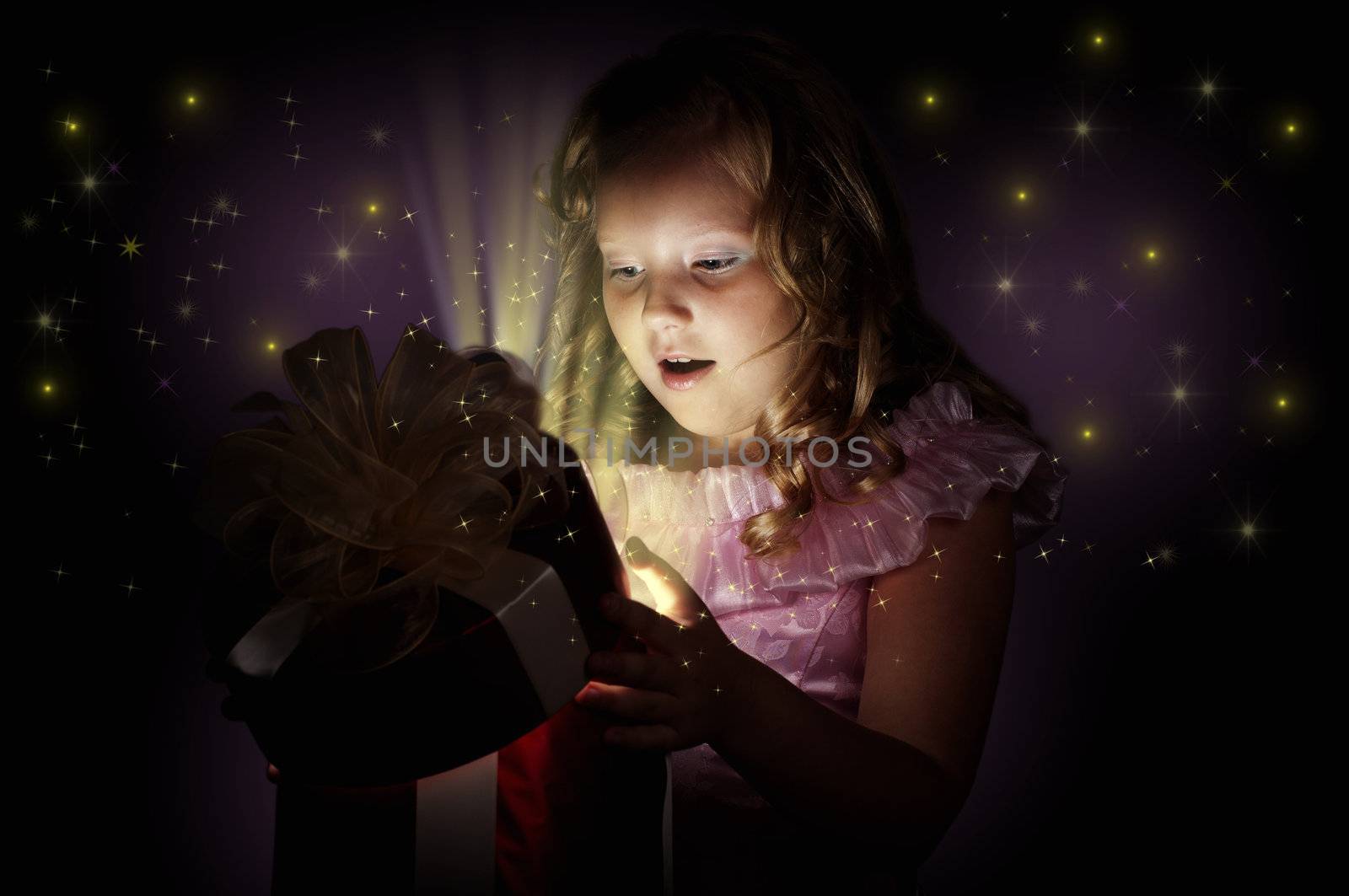 girl opens a box with a gift, beams therefrom shine and magic opens