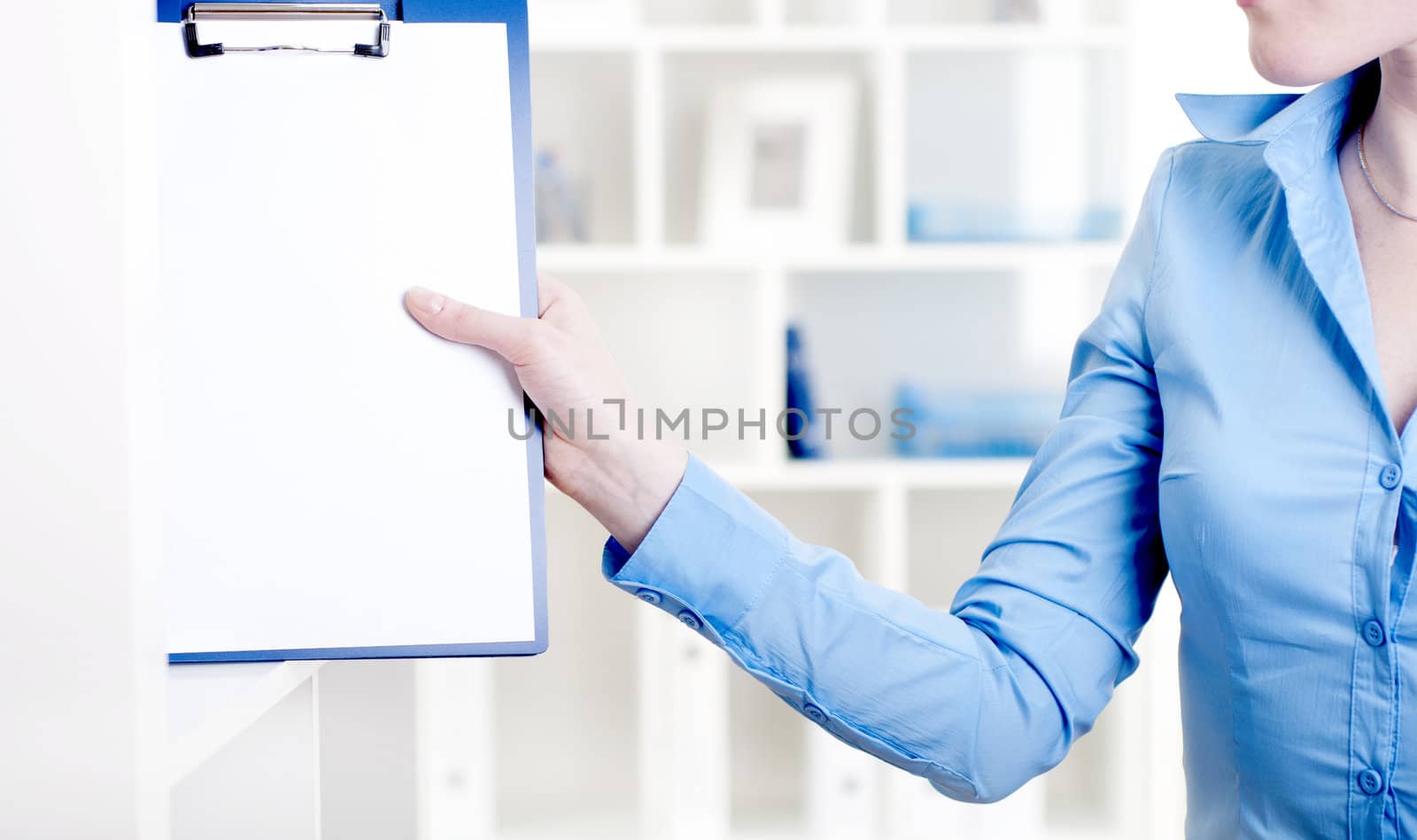 woman puts a tablet with documents in a rack for documents