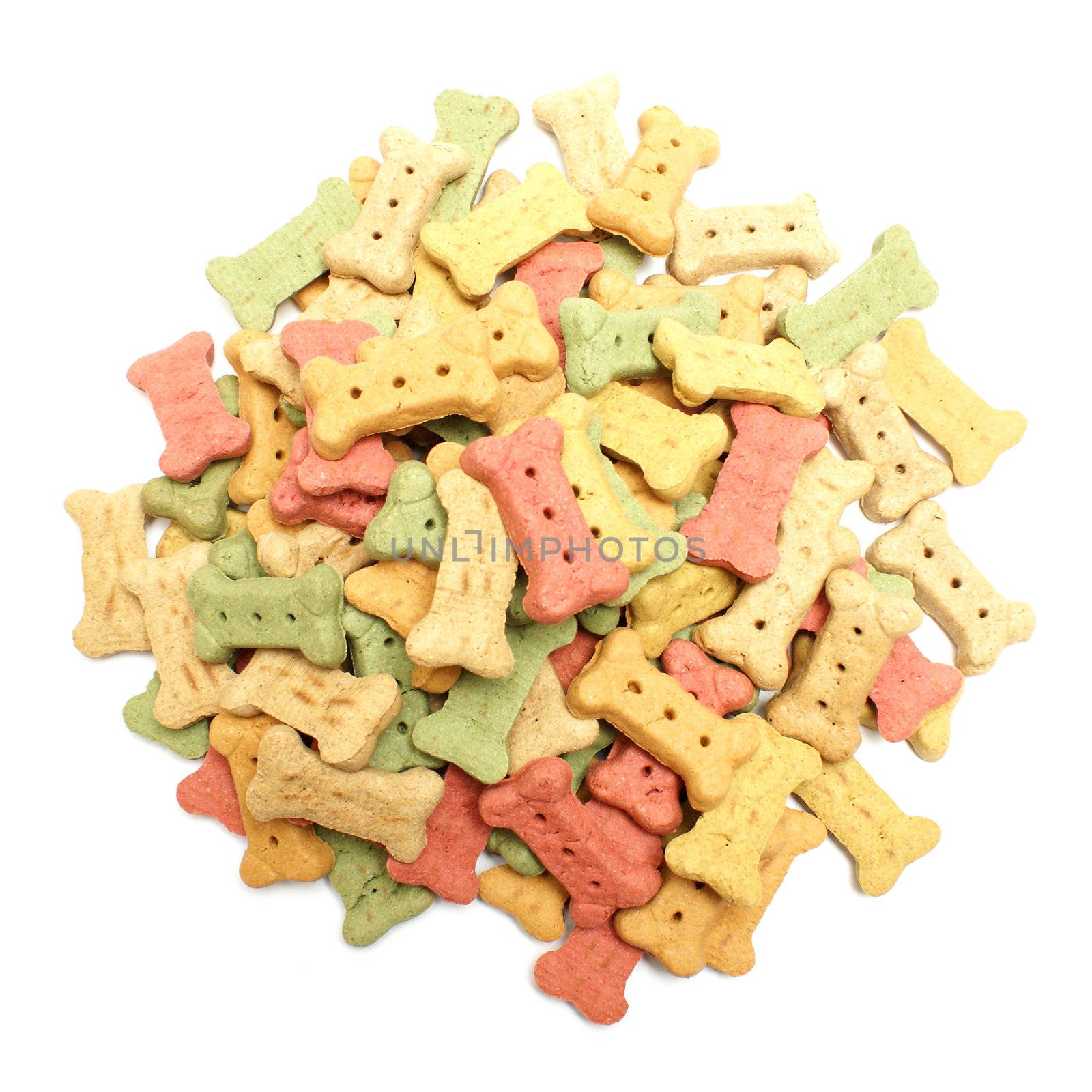 An overhead shot of a pile of bone shaped dog treats isolated on white.