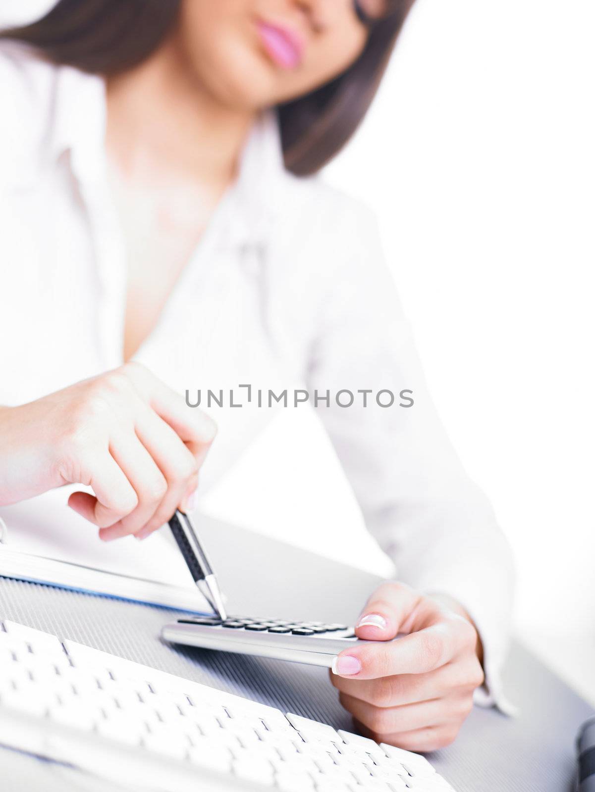 Business woman calculating with calculator and pencil by adamr