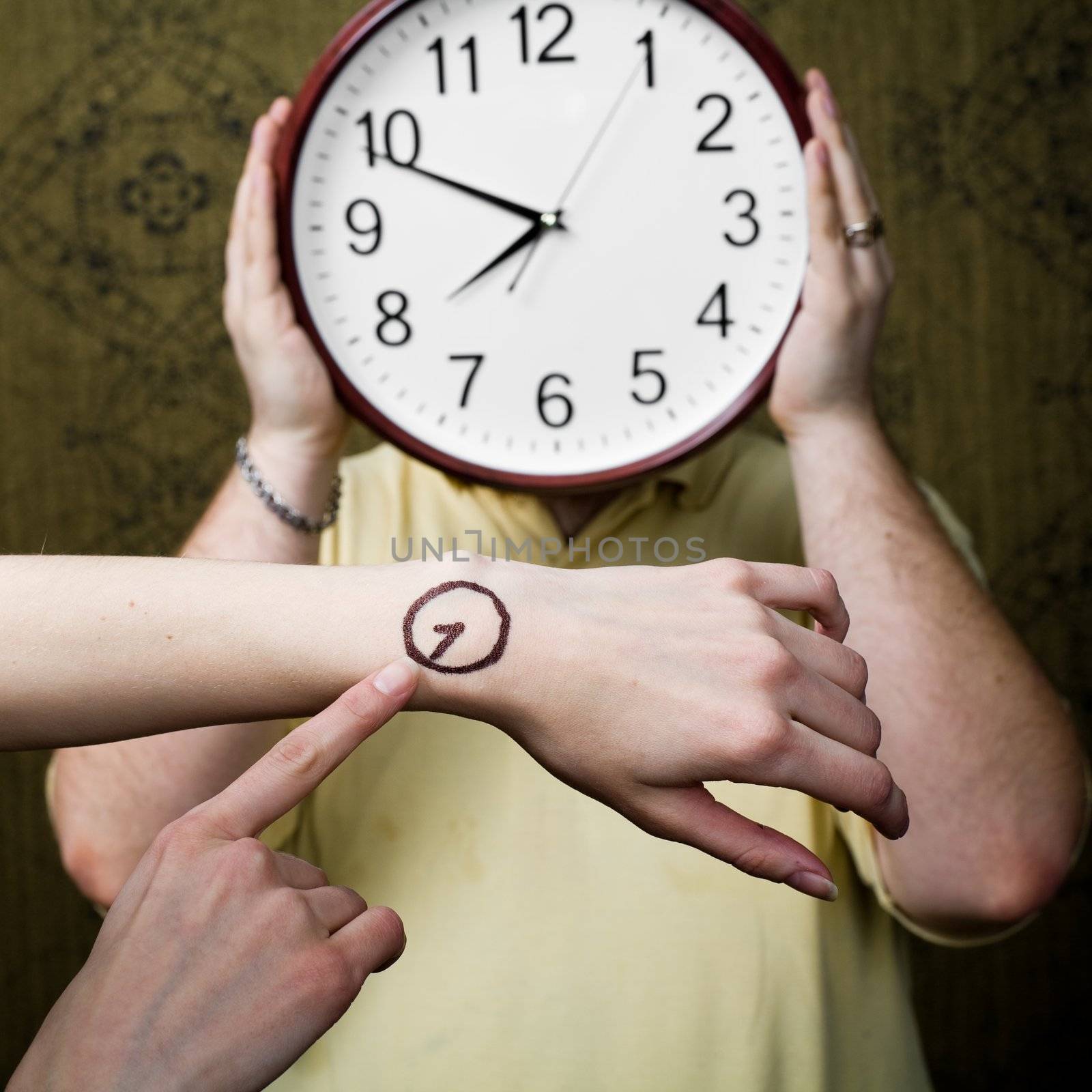 An image of a man with a clock and female hands