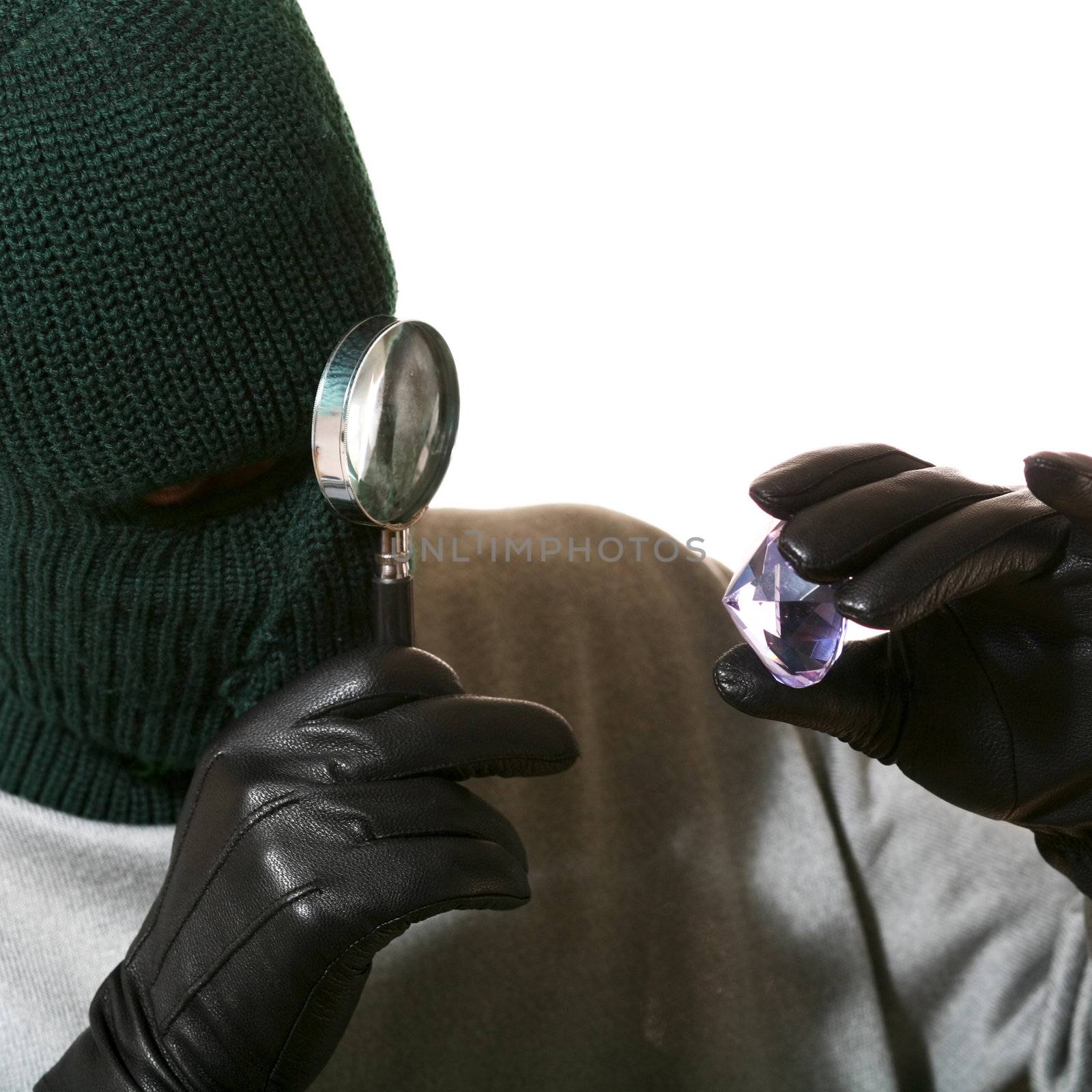 An image of a man in mask with a magnifier and jewel