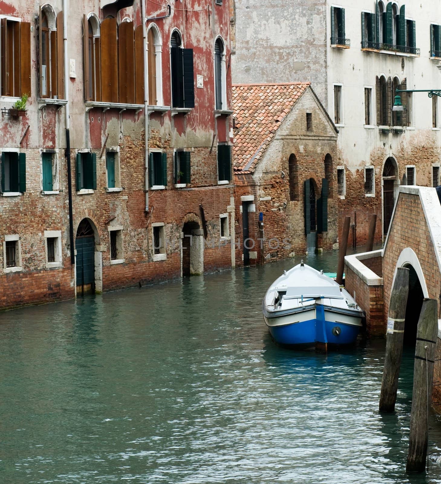 An image of a canal with boat in Venice