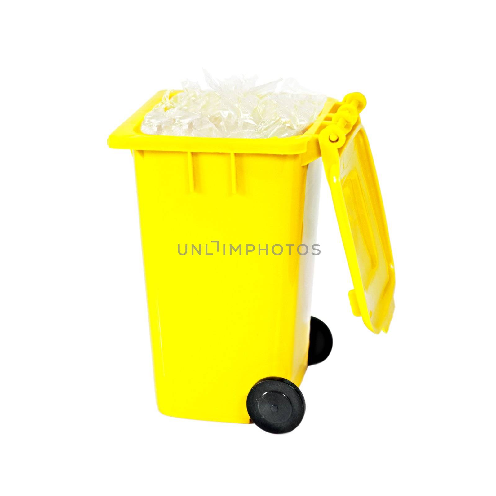 full yellow recycling bin with plastic isolated on white background