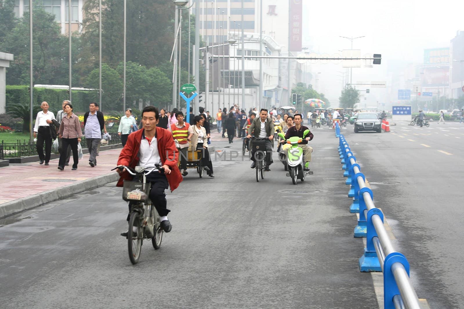 CHENGDU, CHINA - SEPTEMBER 16: Special line for bicyles, pedicabs on the multilane road on September 16, 2006 in Chengdu, Sichuan, China