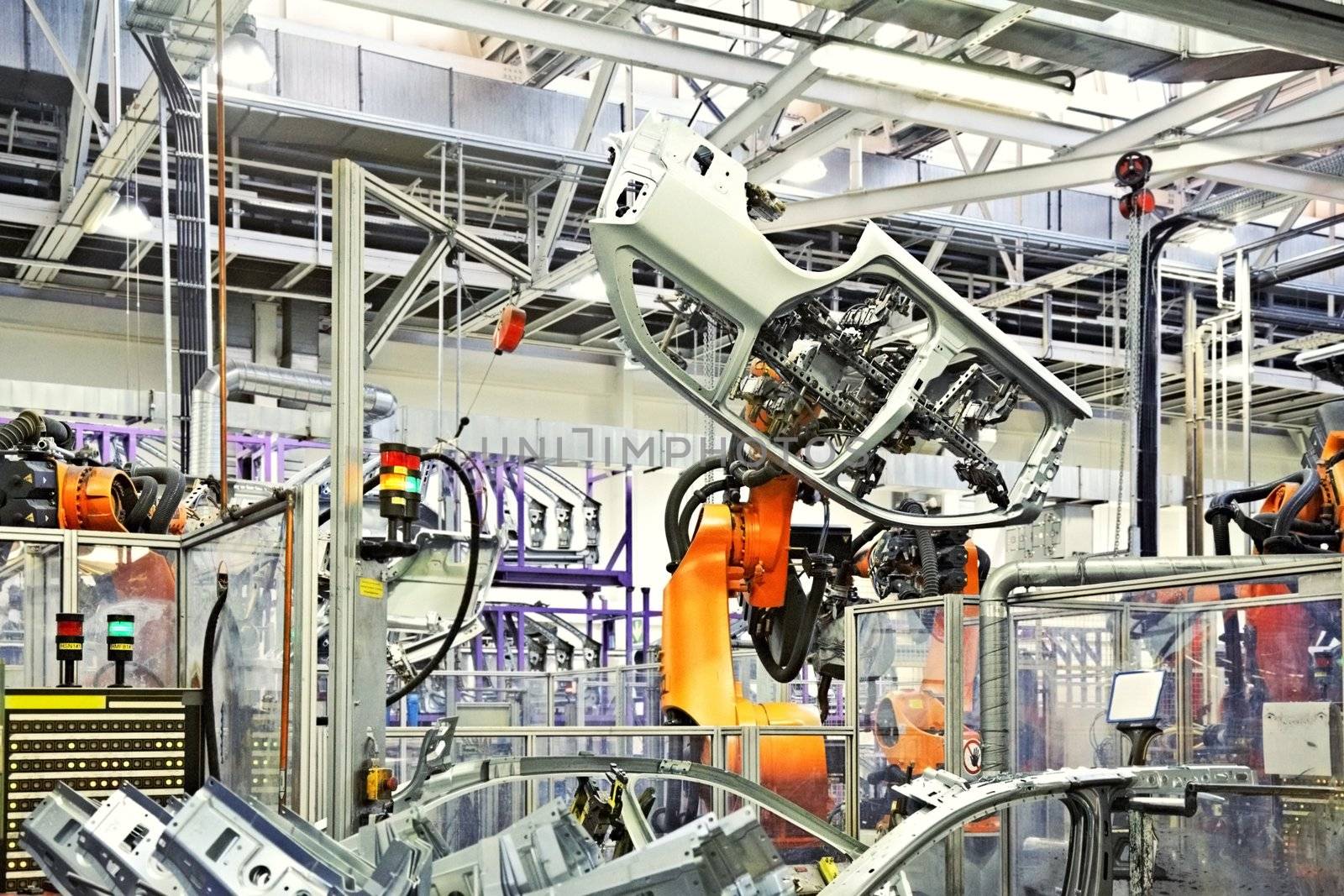 robotic arms in a car factory