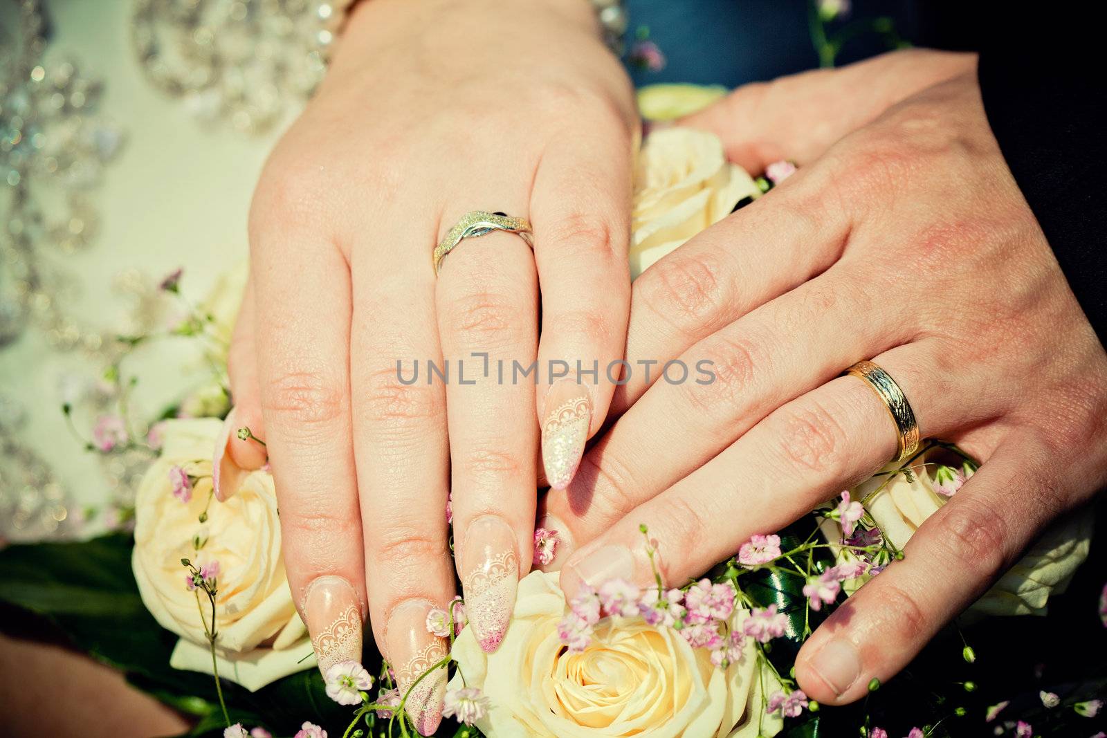 hands of bride and groom with wedding bouquet by zhu_zhu