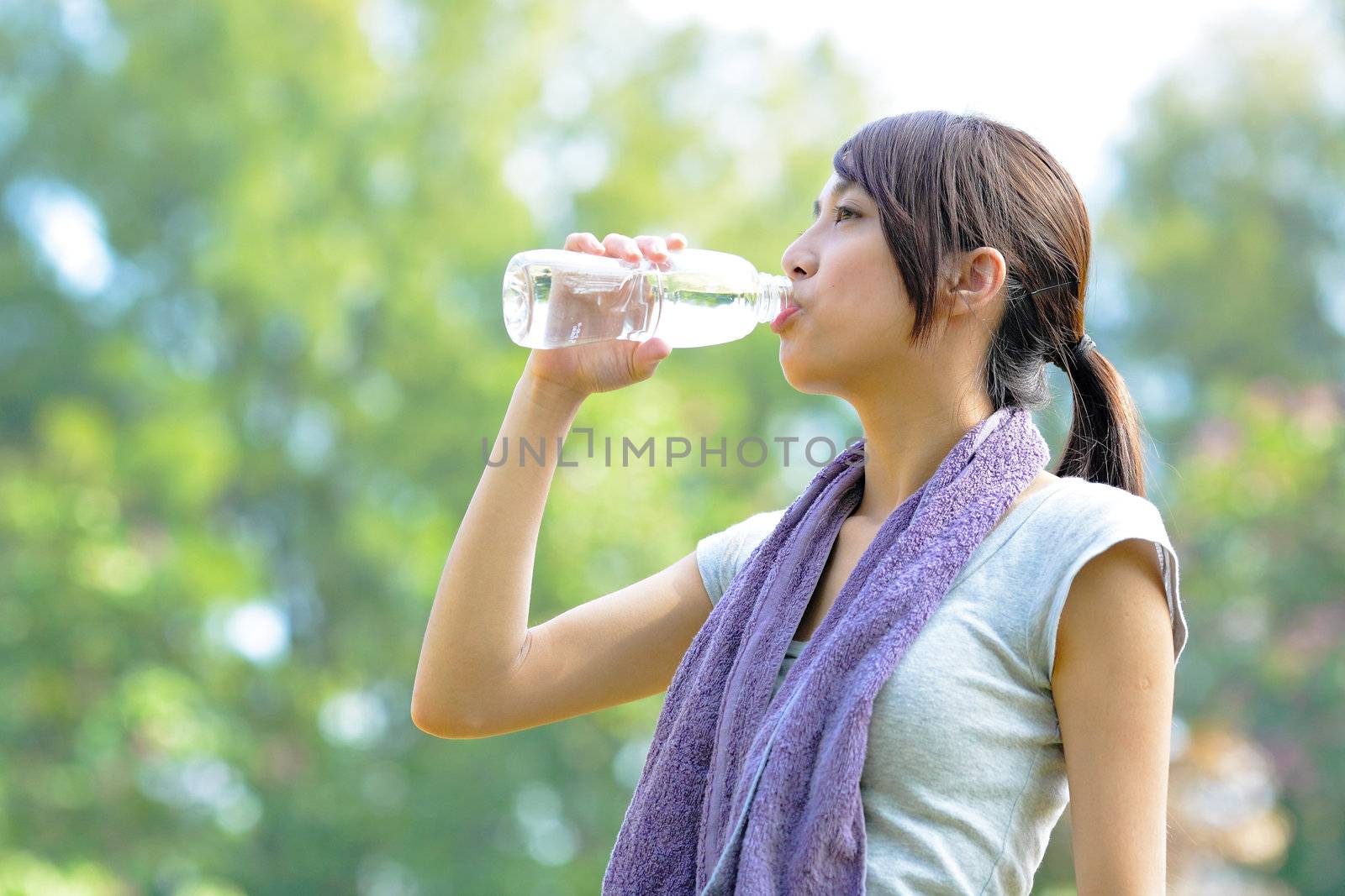 woman drink water after sport by leungchopan
