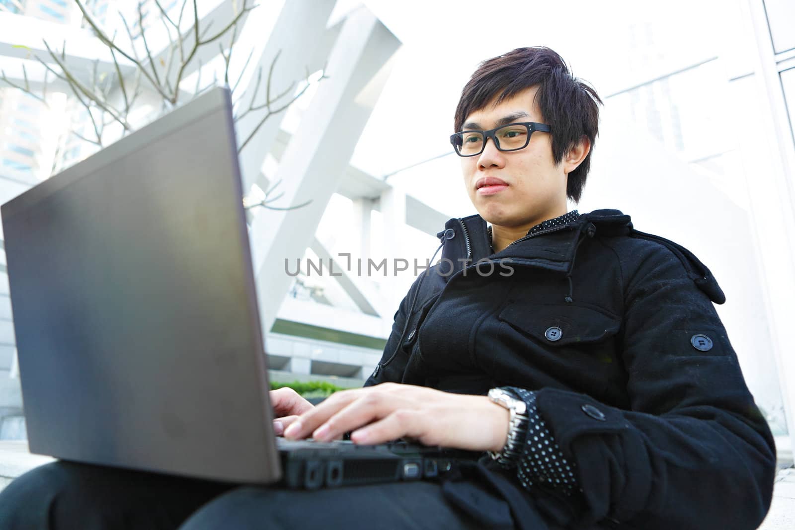 man using computer outdoor by leungchopan