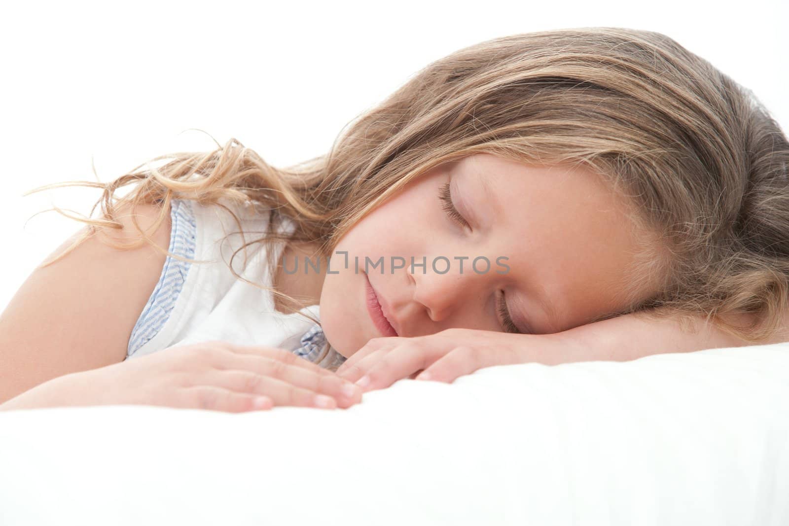 High key Close up of sweet little girl sleeping. Isolated on white background.