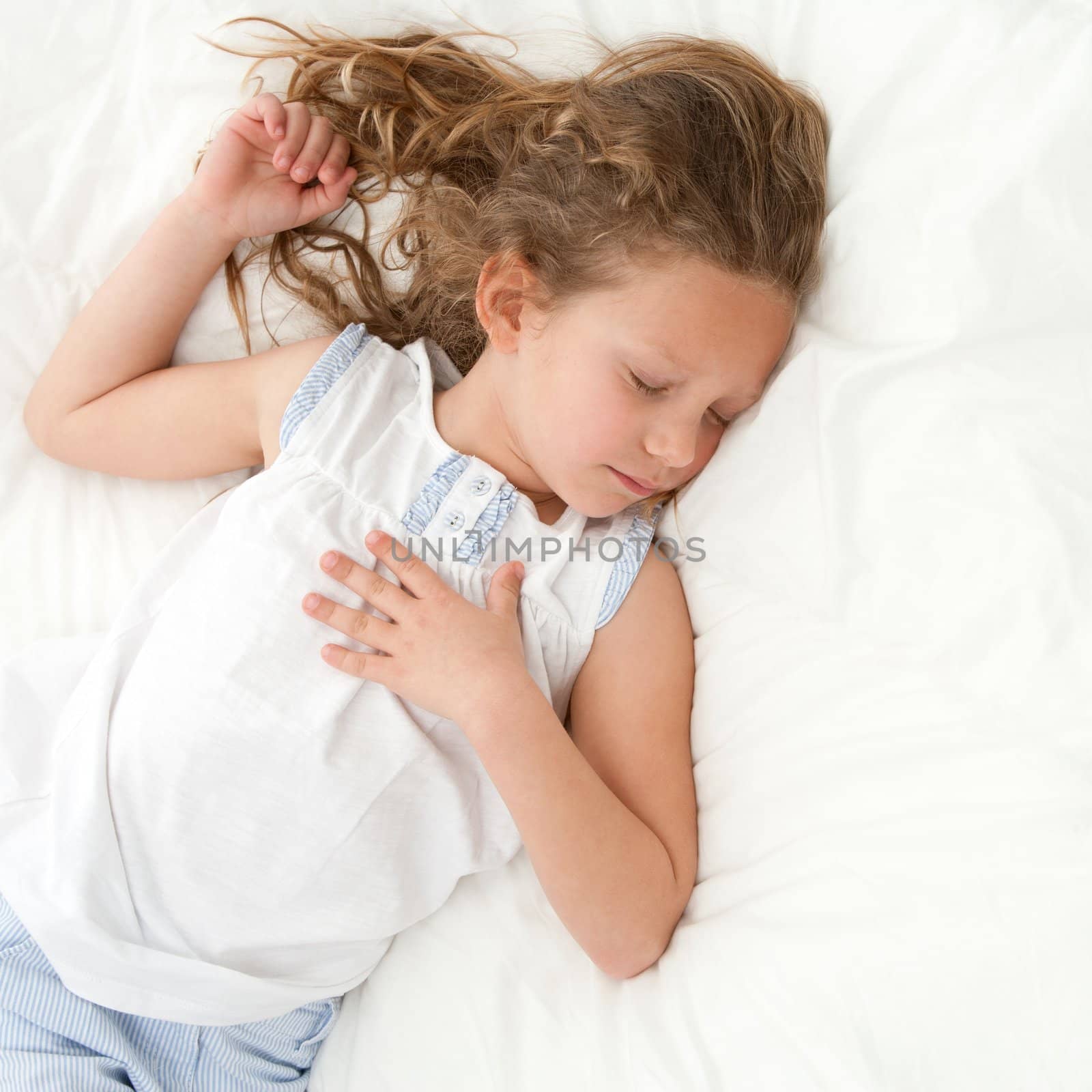 Young little girl sleeping with peaceful face expression.