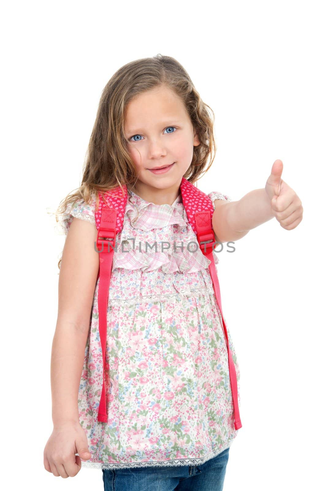 Portrait of cute blond schoolgirl showing thumbs up. Isolated on white.