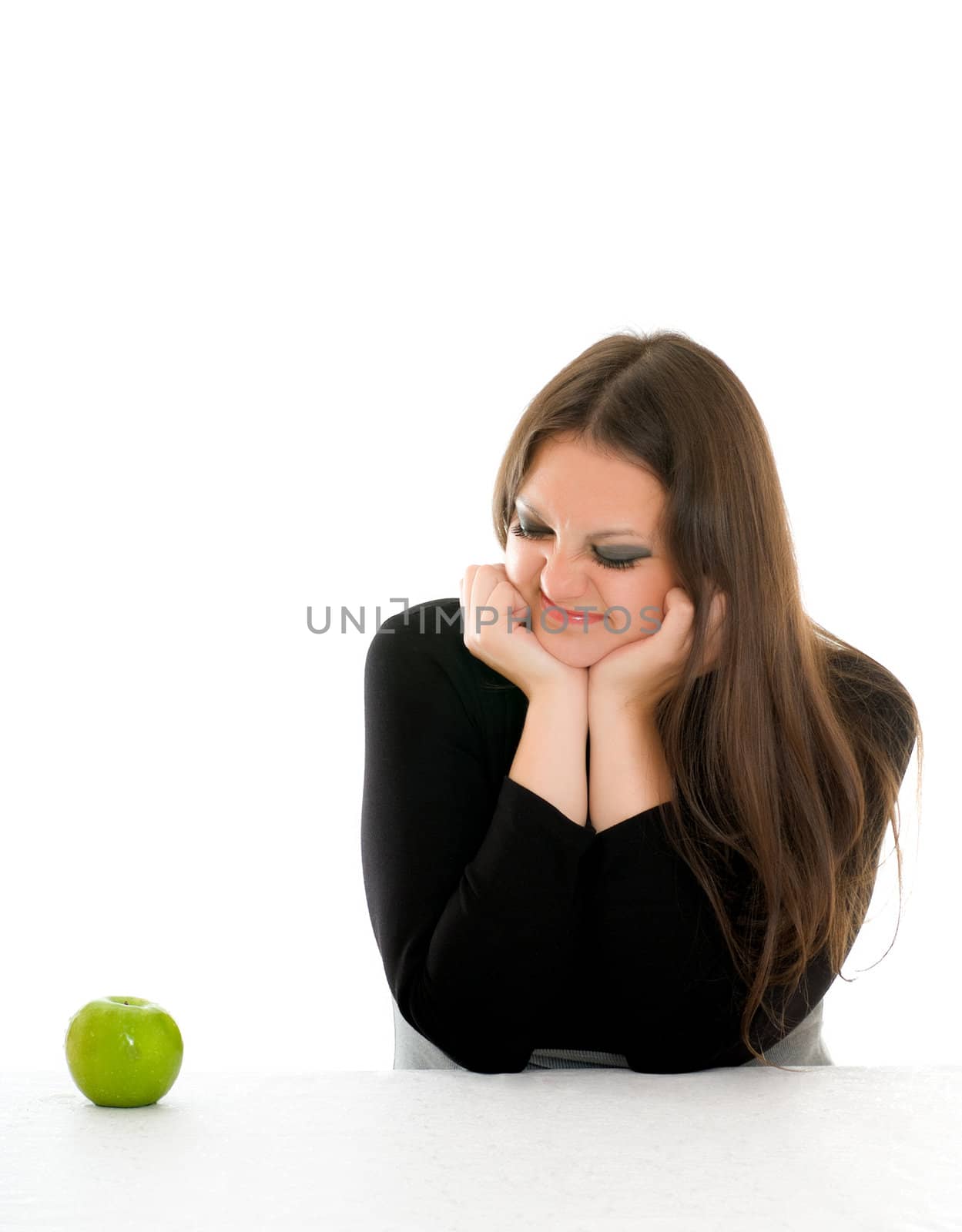 girl with grimace on her face and green apple by petr_malyshev