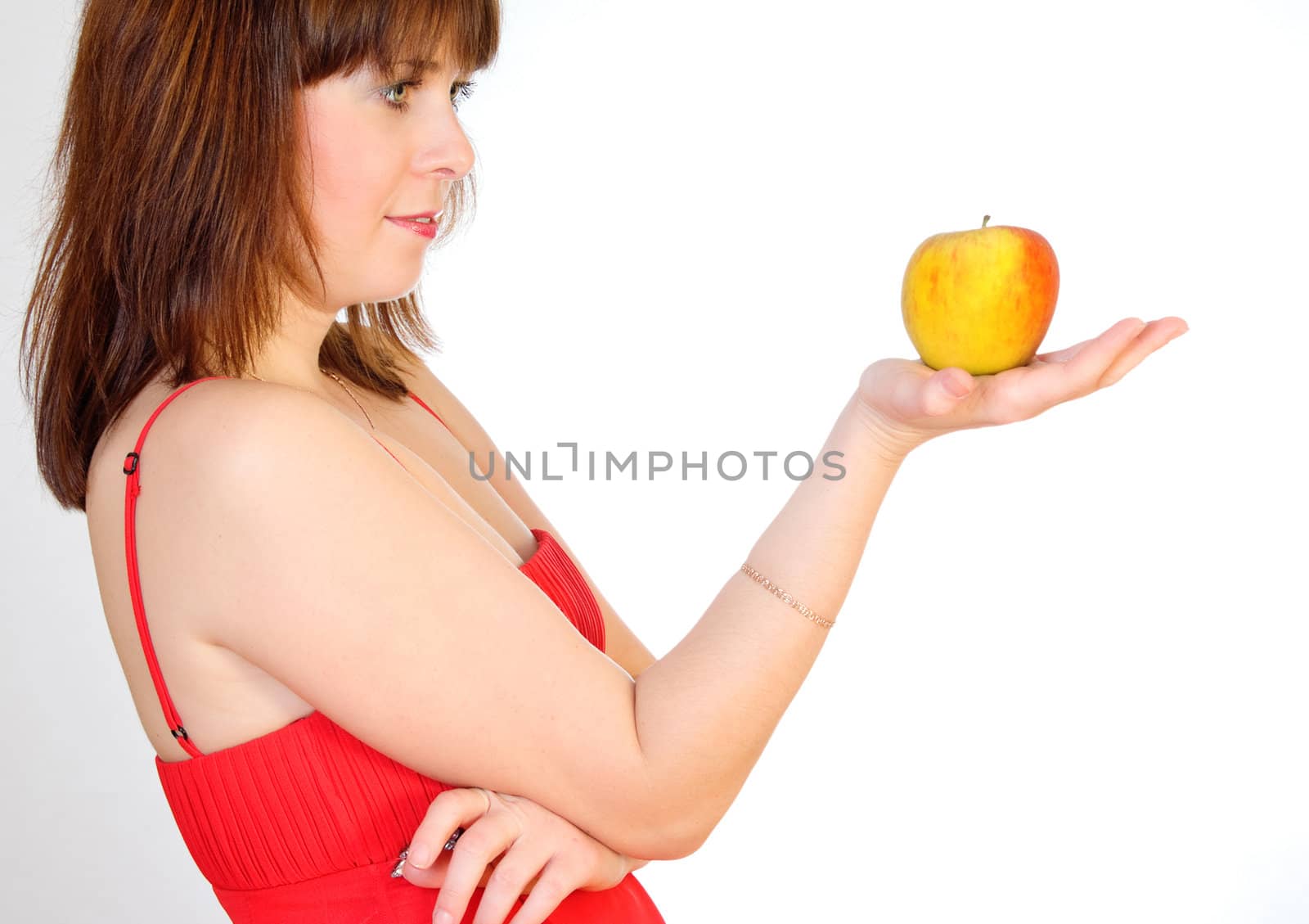 beautiful girl with apple on palm on grey background
