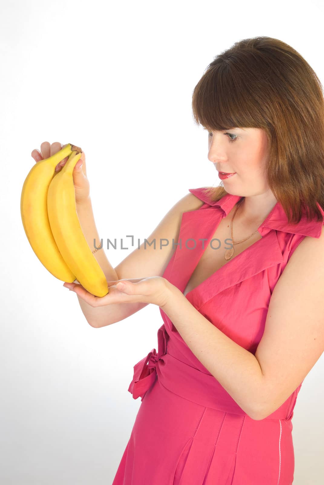 beautiful girl with bananas in hand on grey background