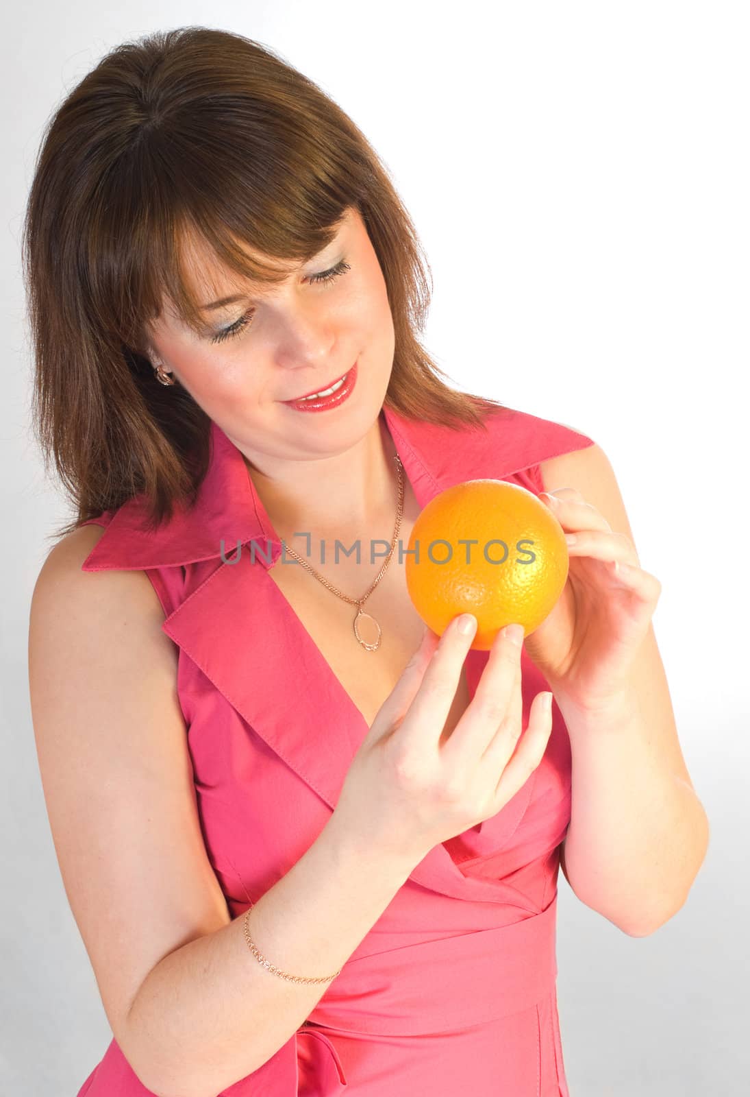 beautiful girl with orange in hands by petr_malyshev