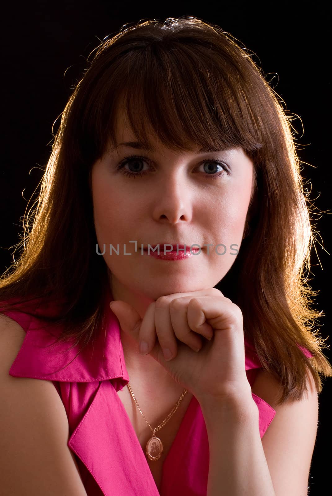 portrait of beautiful girl with brown hair and grey eyes on black background