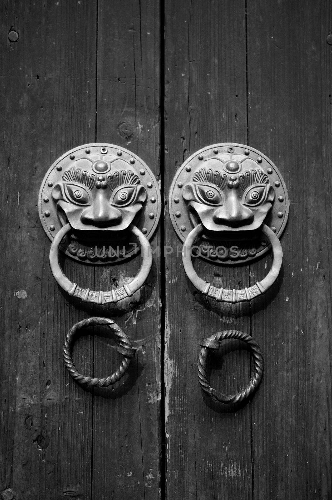 Chinese door in black and white tone, double lion knobs.