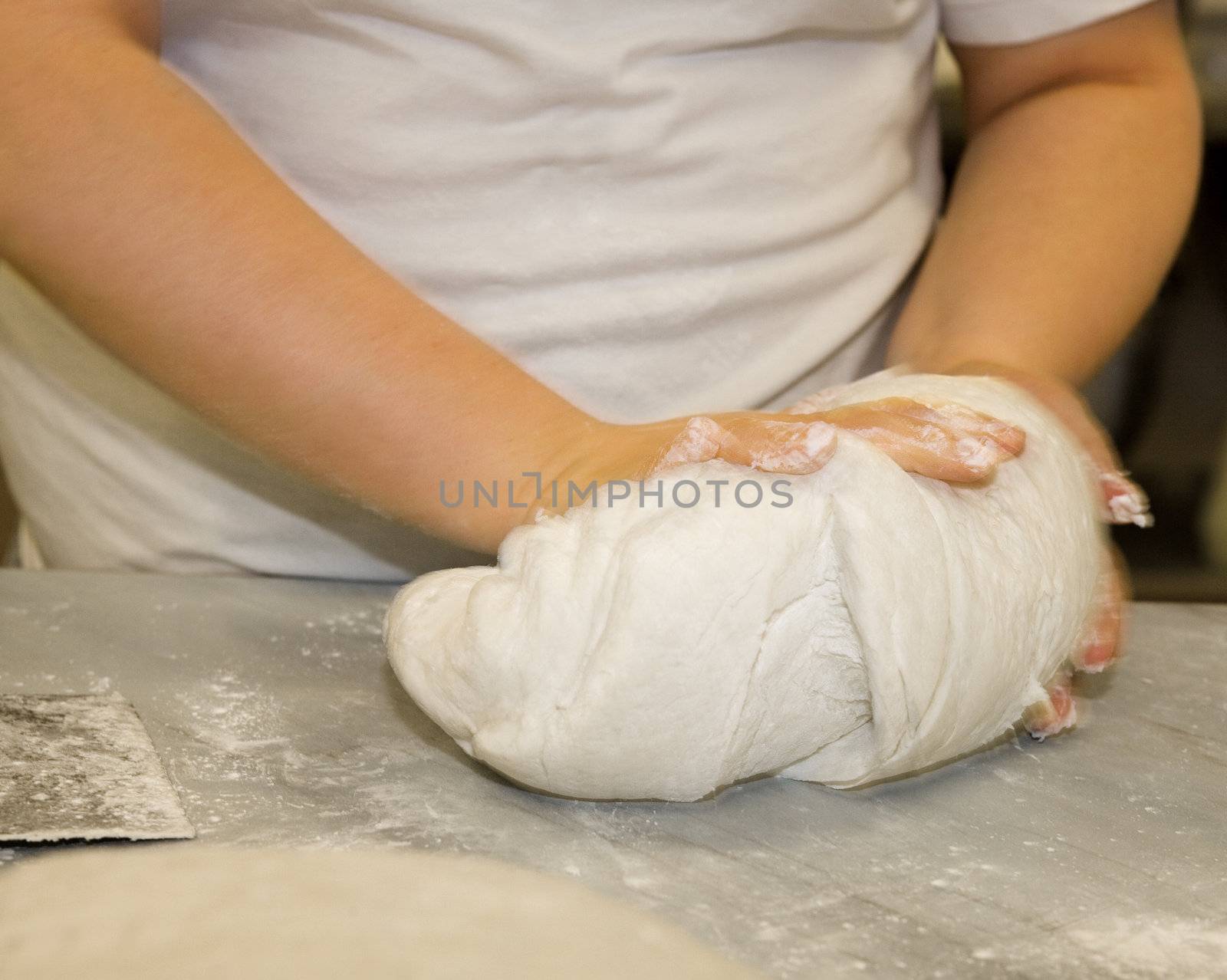 Close up of a woman kneading dough