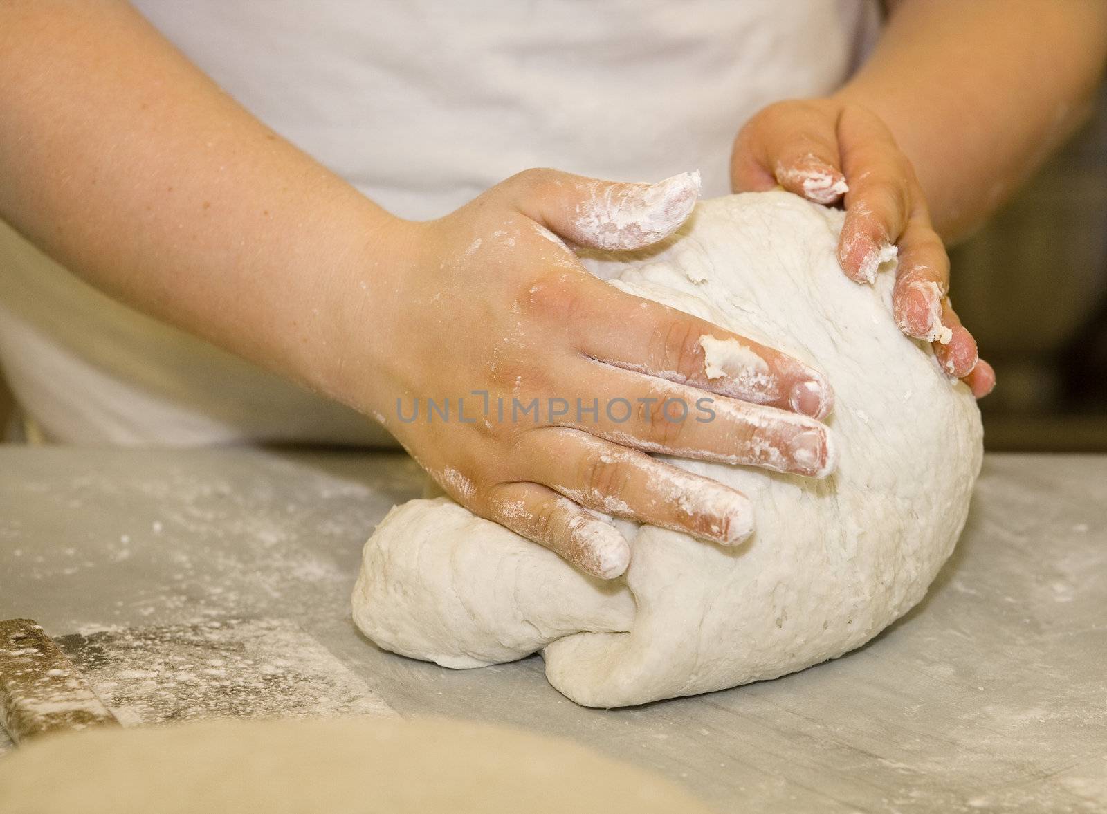 Close up of a woman kneading dough