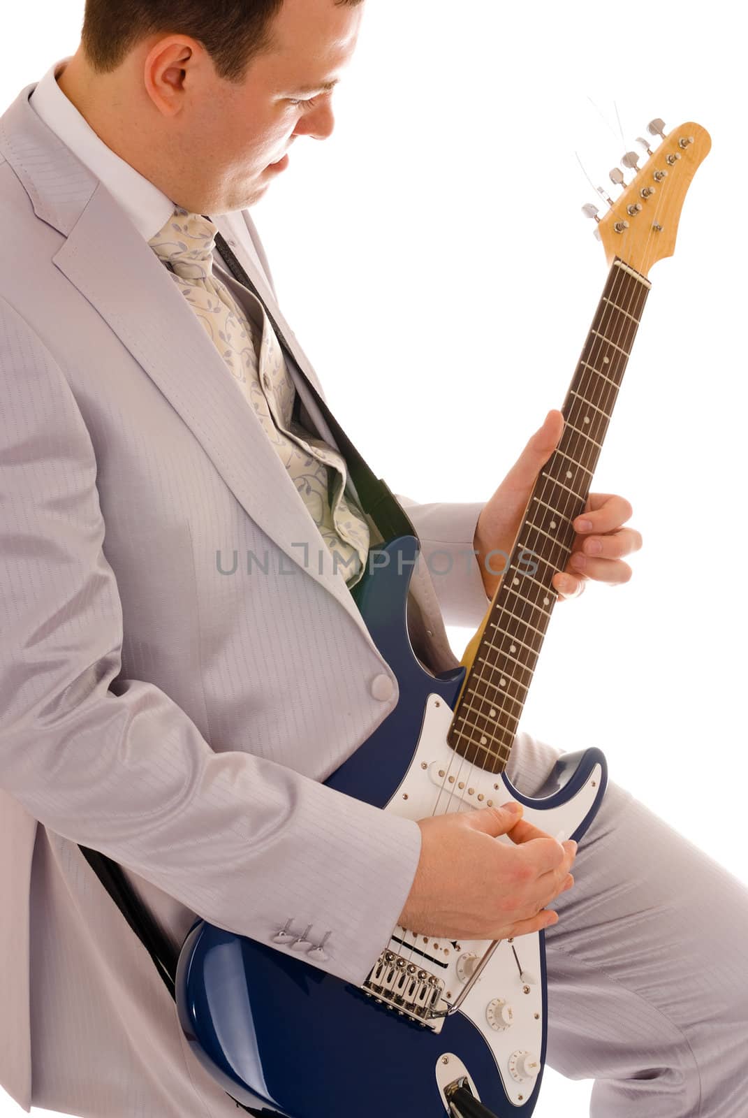 man in white suit playing guitar, white background