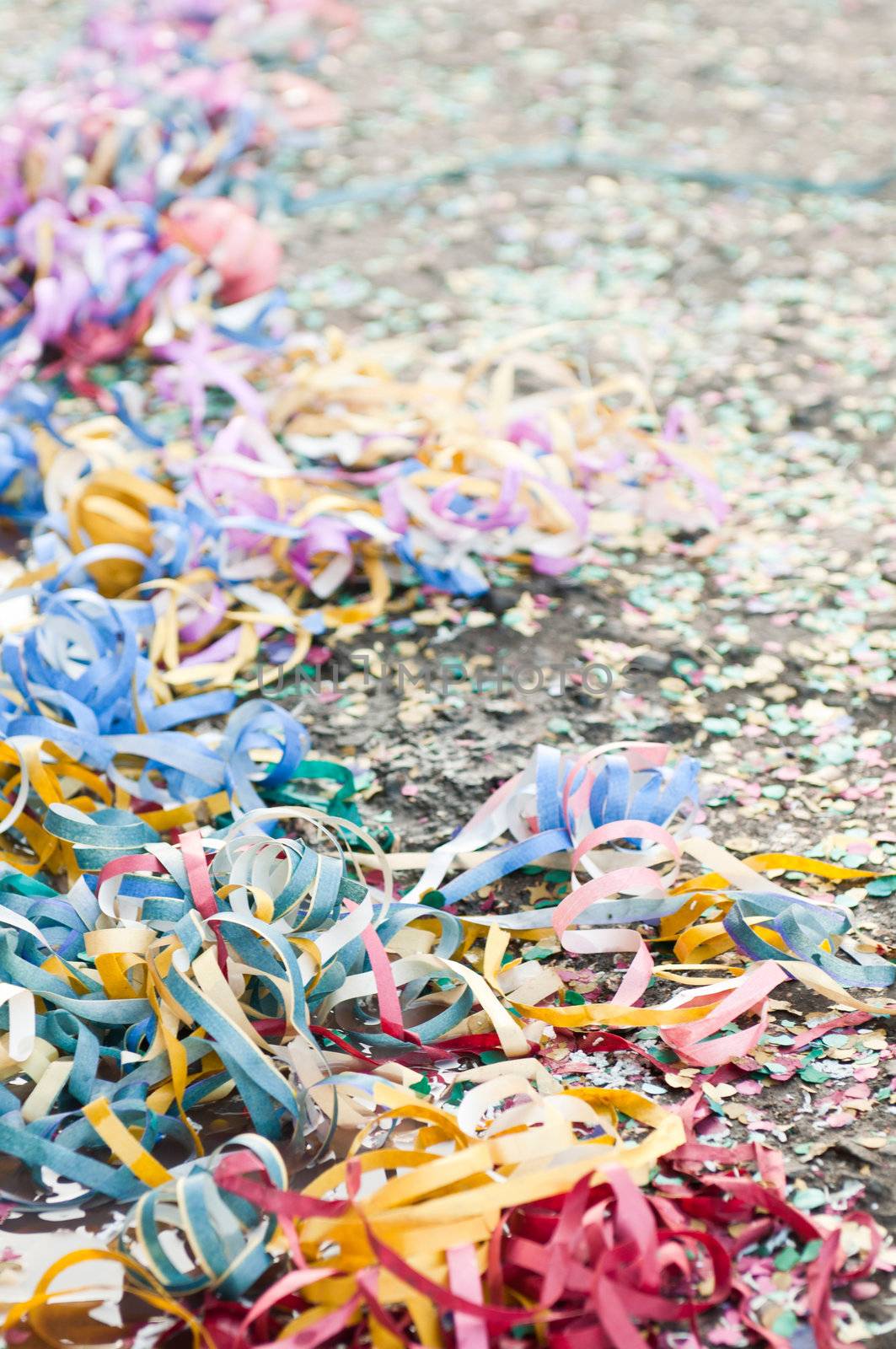 colorful confetti and streamers at the street after Carnival Parade (shallow DOF)