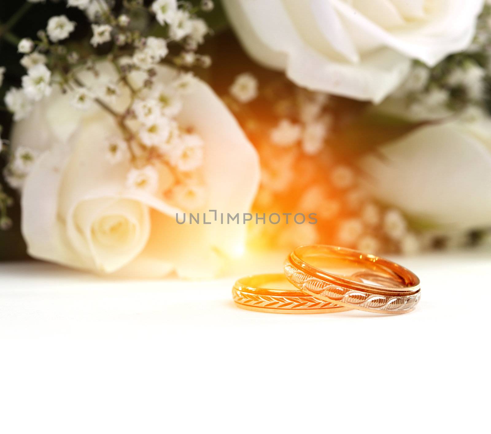 Wedding rings and roses bouquet by rudchenko