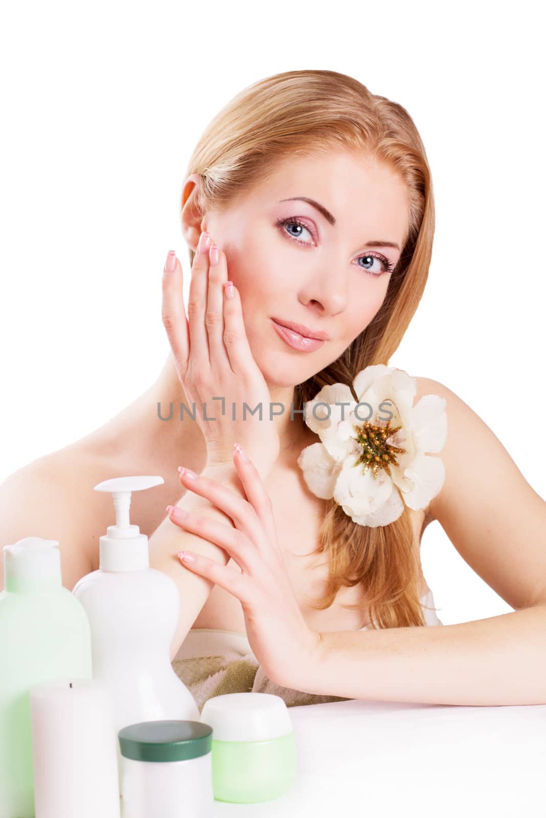 Sensual woman with skincare and nail products isolated on white