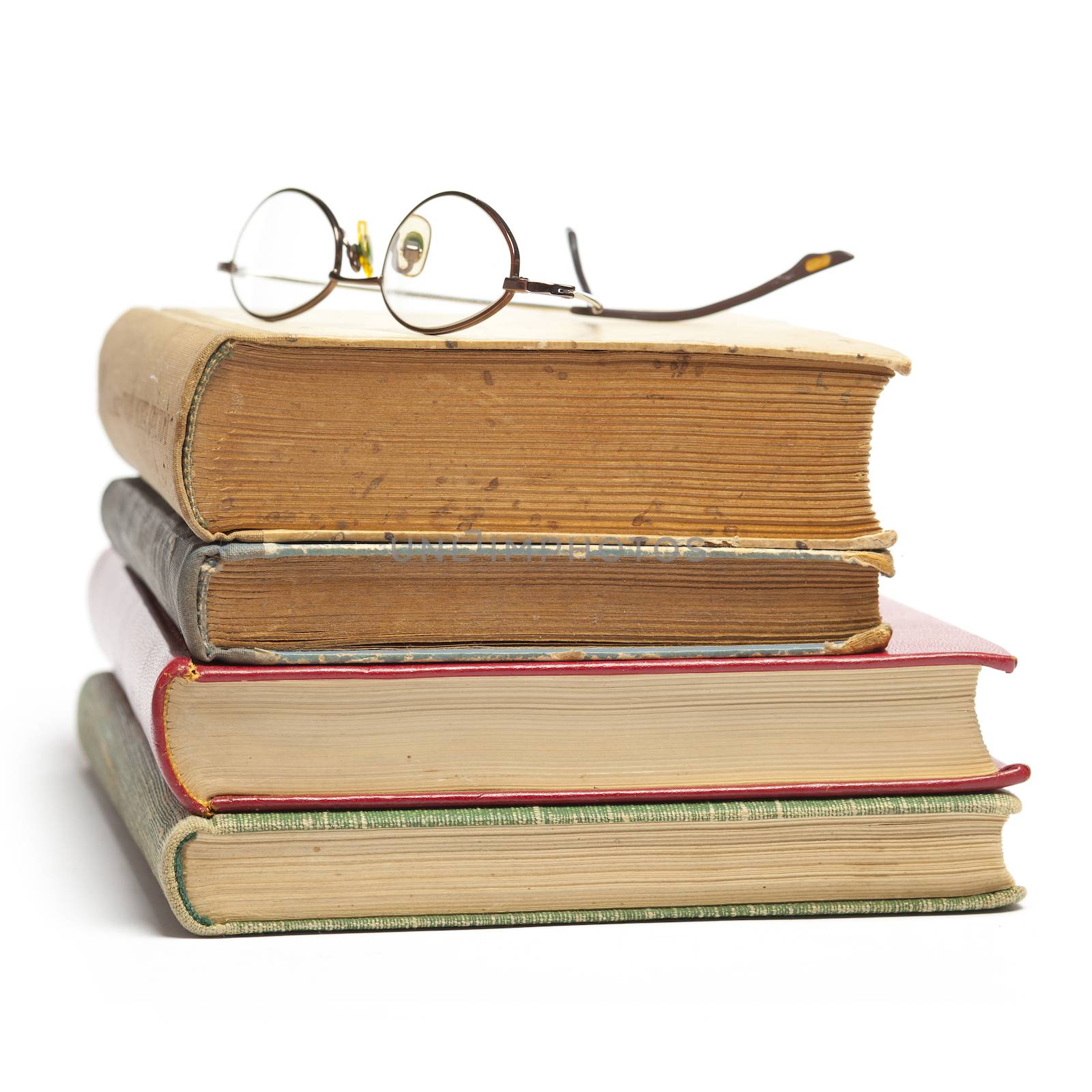 Group of Old Antique Books and eyeglasses isolated on white