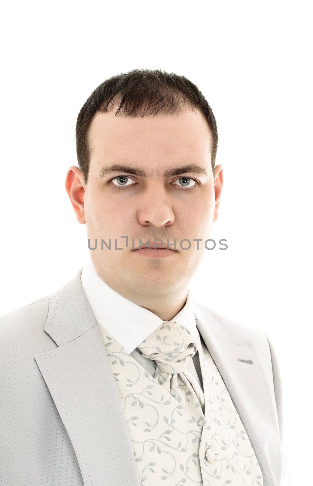 serious young man in wedding suit isolated on white background