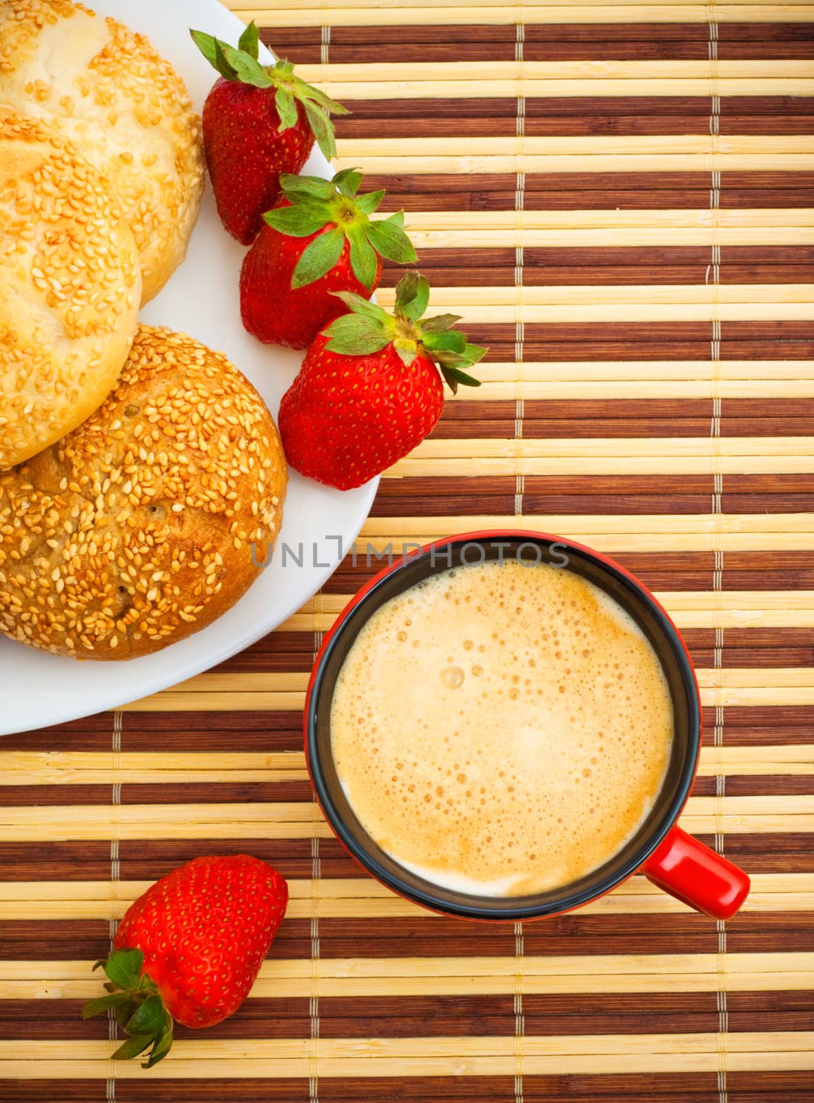 coffee, buns and strawberries on table, top view