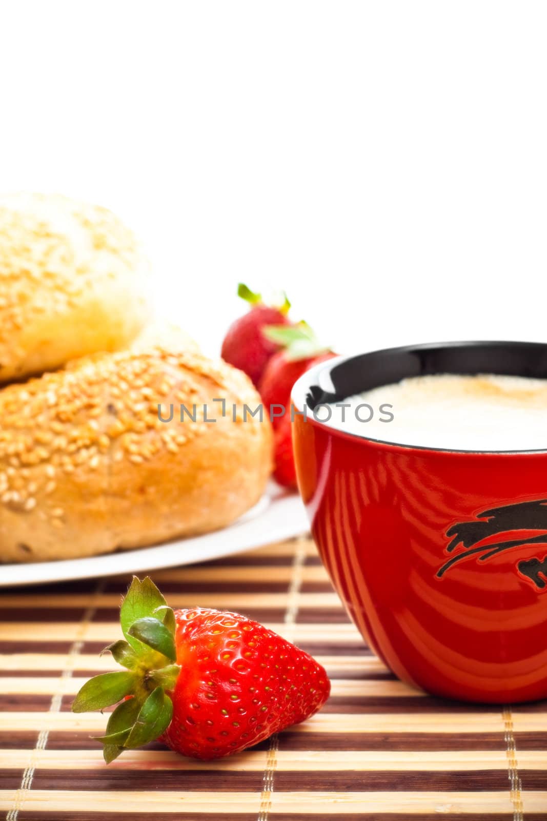 coffee, buns and strawberries on table