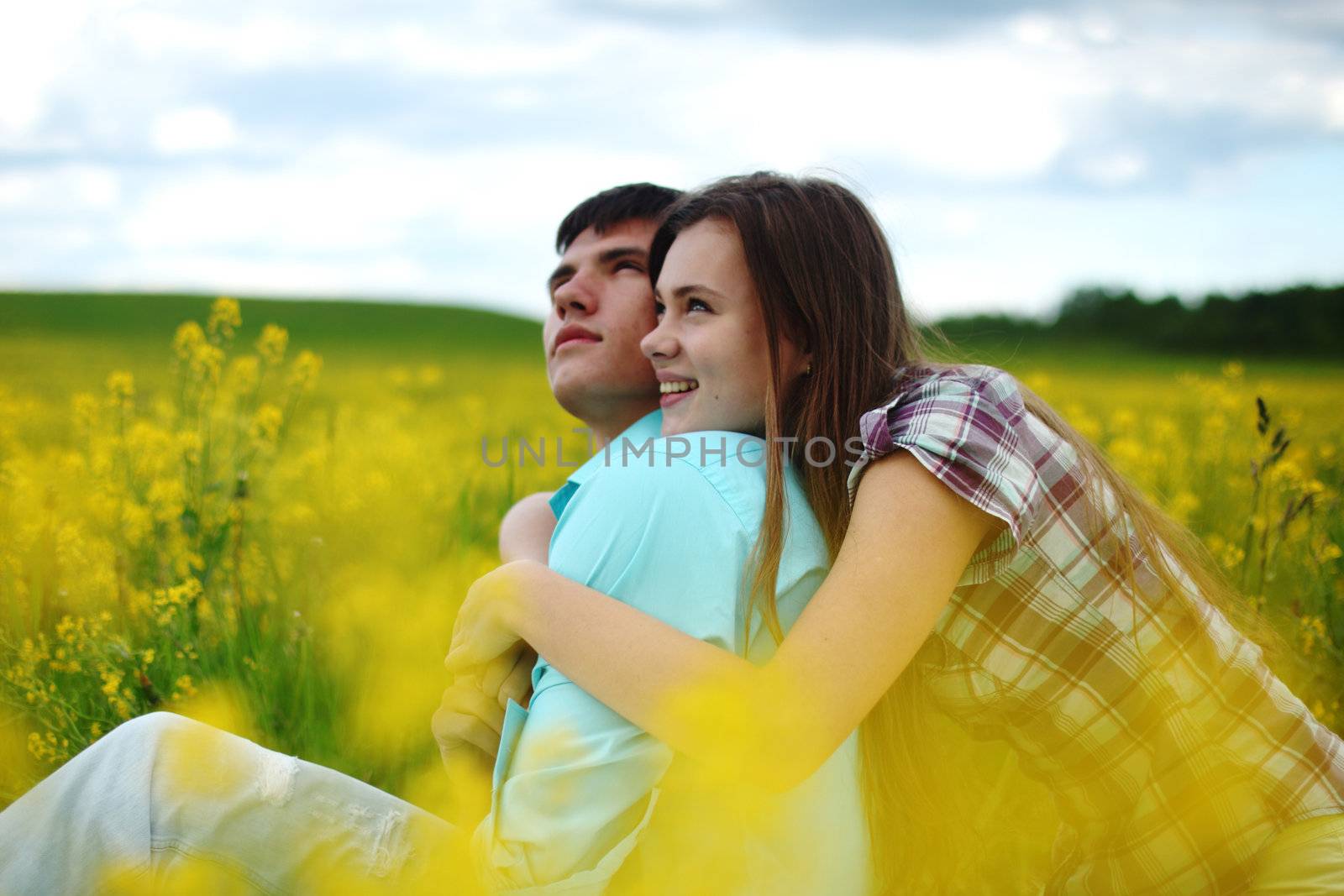 lovers hug on yellow flower field